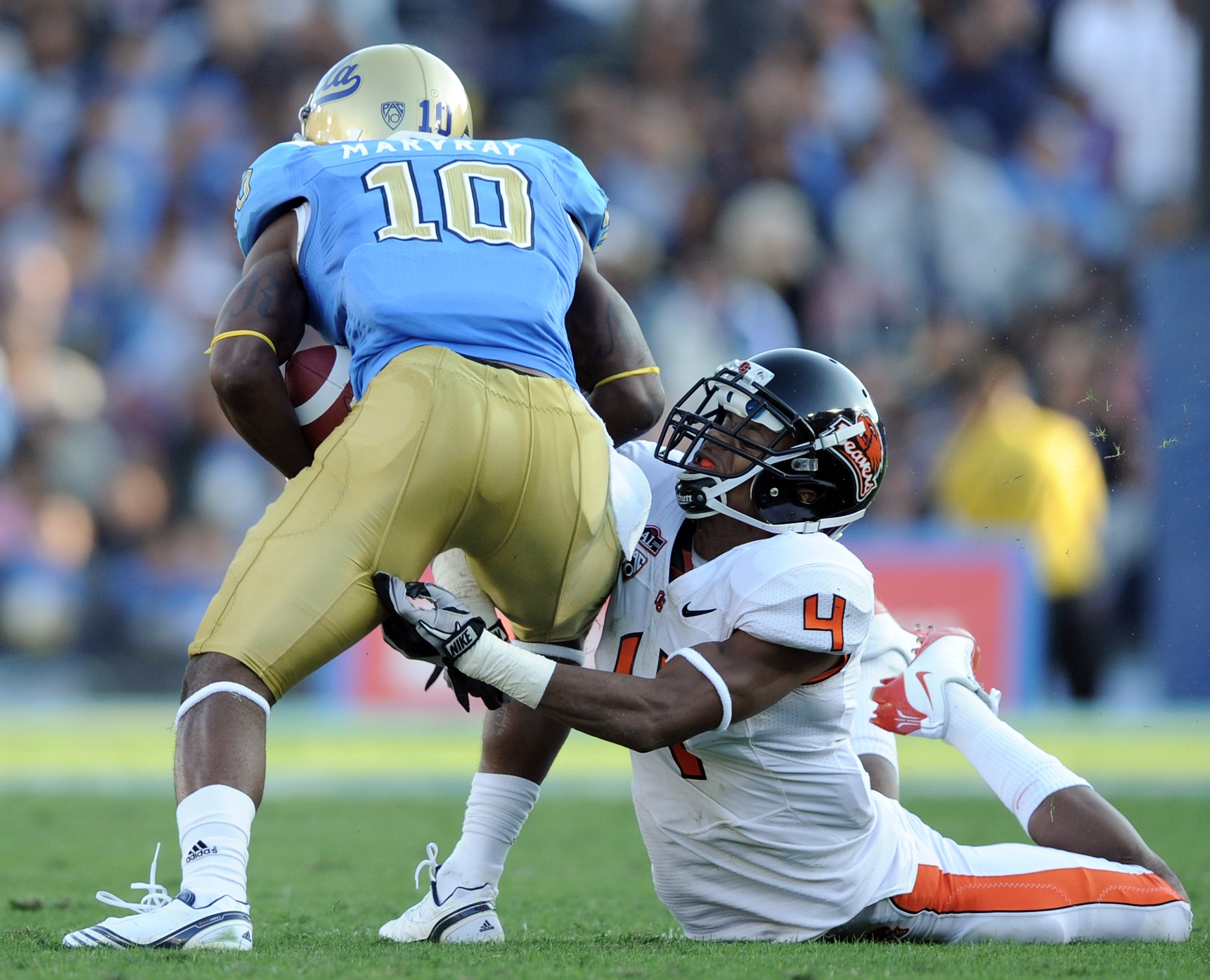 PASADENA, CA - NOVEMBER 06:  James Dockery #4 of the Oregon State Beavers attempts to tackle Akeem Ayers #10 of the UCLA Bruins after a catch at the Rose Bowl on November 6, 2010 in Pasadena, California.  (Photo by Harry How/Getty Images)