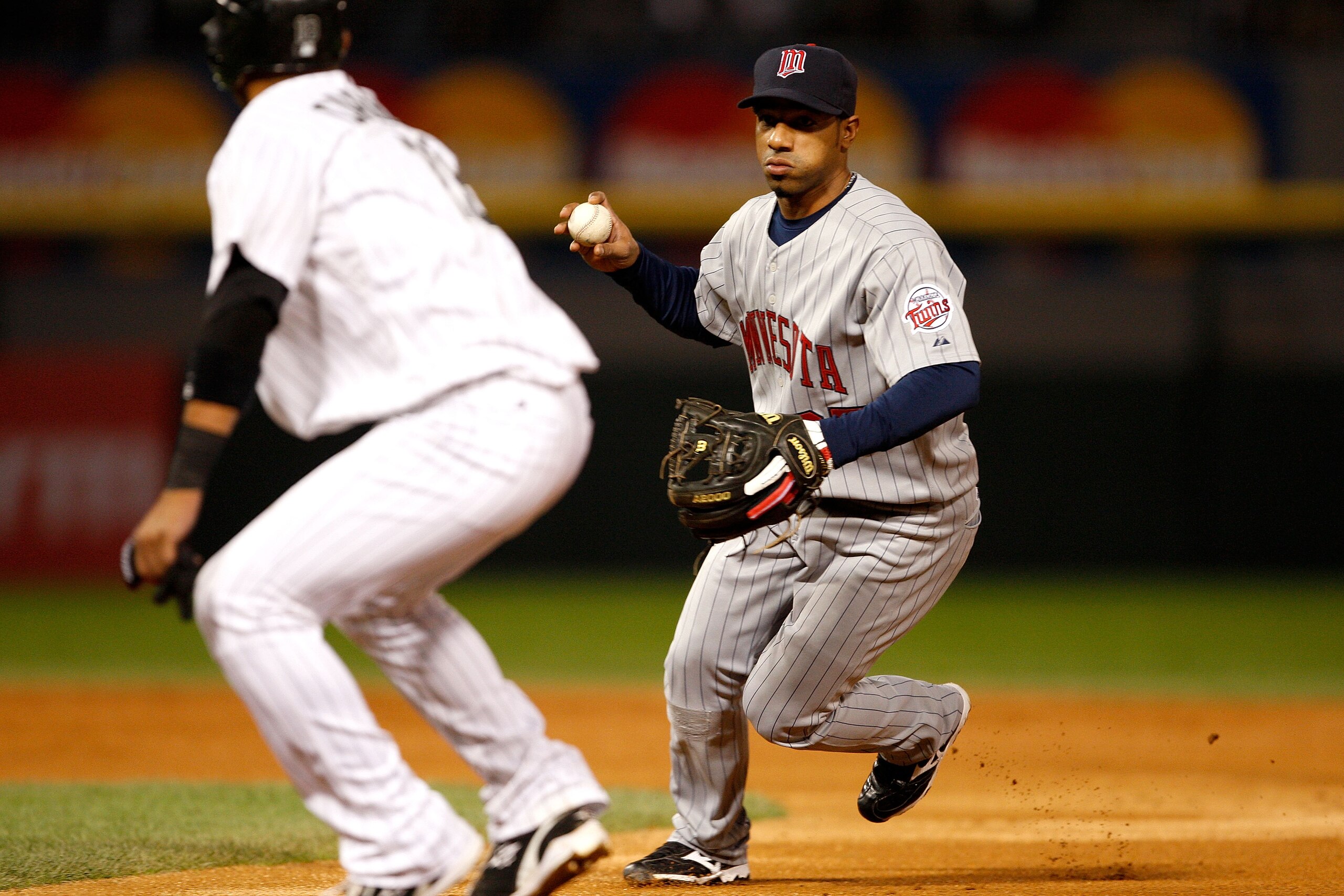 CHICAGO - SEPTEMBER 30:  Alexi Casilla #25 of the Minnesota Twins catches Orlando Cabrera #18 of the Chicago White Sox in a run down during the American League Central Division Tiebreaker game at U.S. Cellular Field on September 30, 2008 in Chicago, Illin
