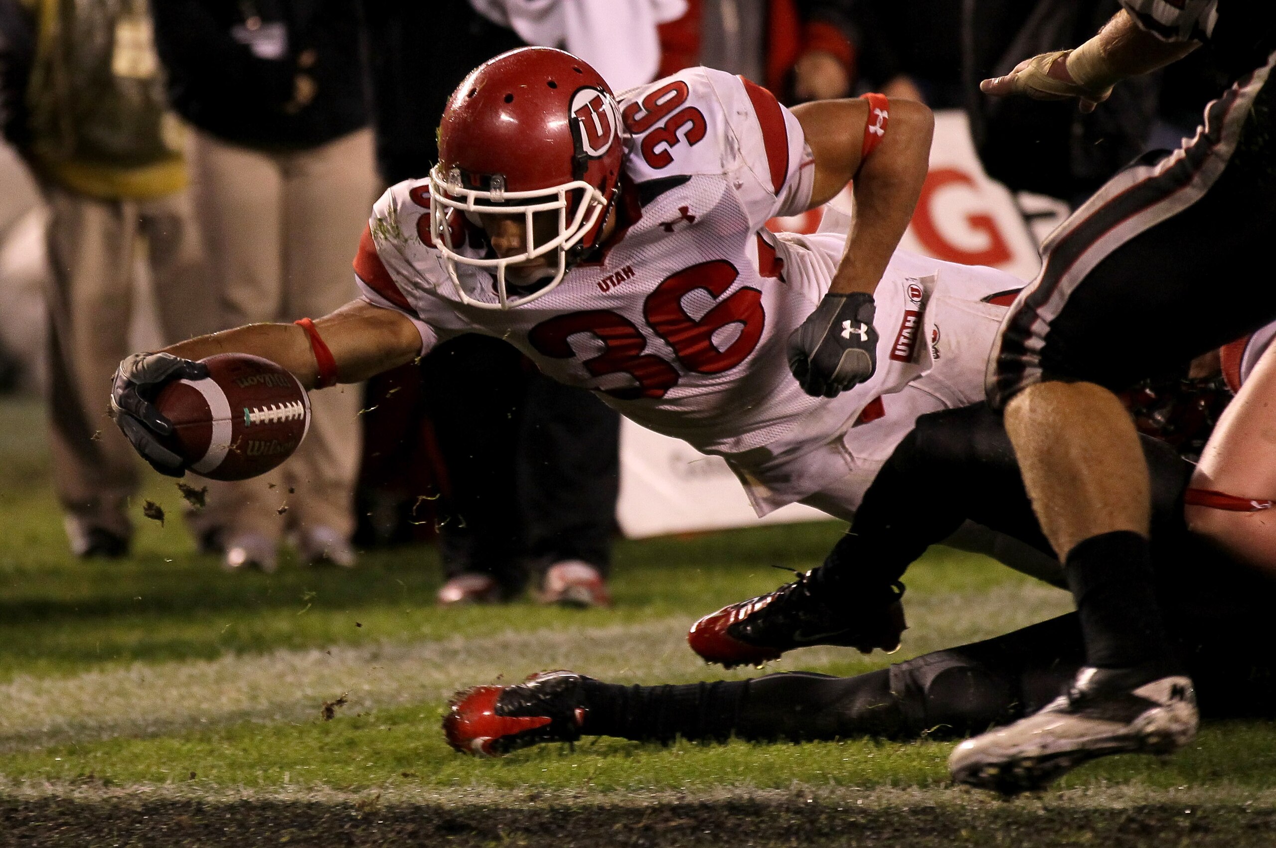 SAN DIEGO - NOVEMBER 20:  Running back Eddie Wide #36 of the Utah Utes reaches the ball over the goal line to score the winning touchdown on a one yard carry in the fourth quarter against the San Diego State Aztecs at Qualcomm Stadium on November 20, 2010