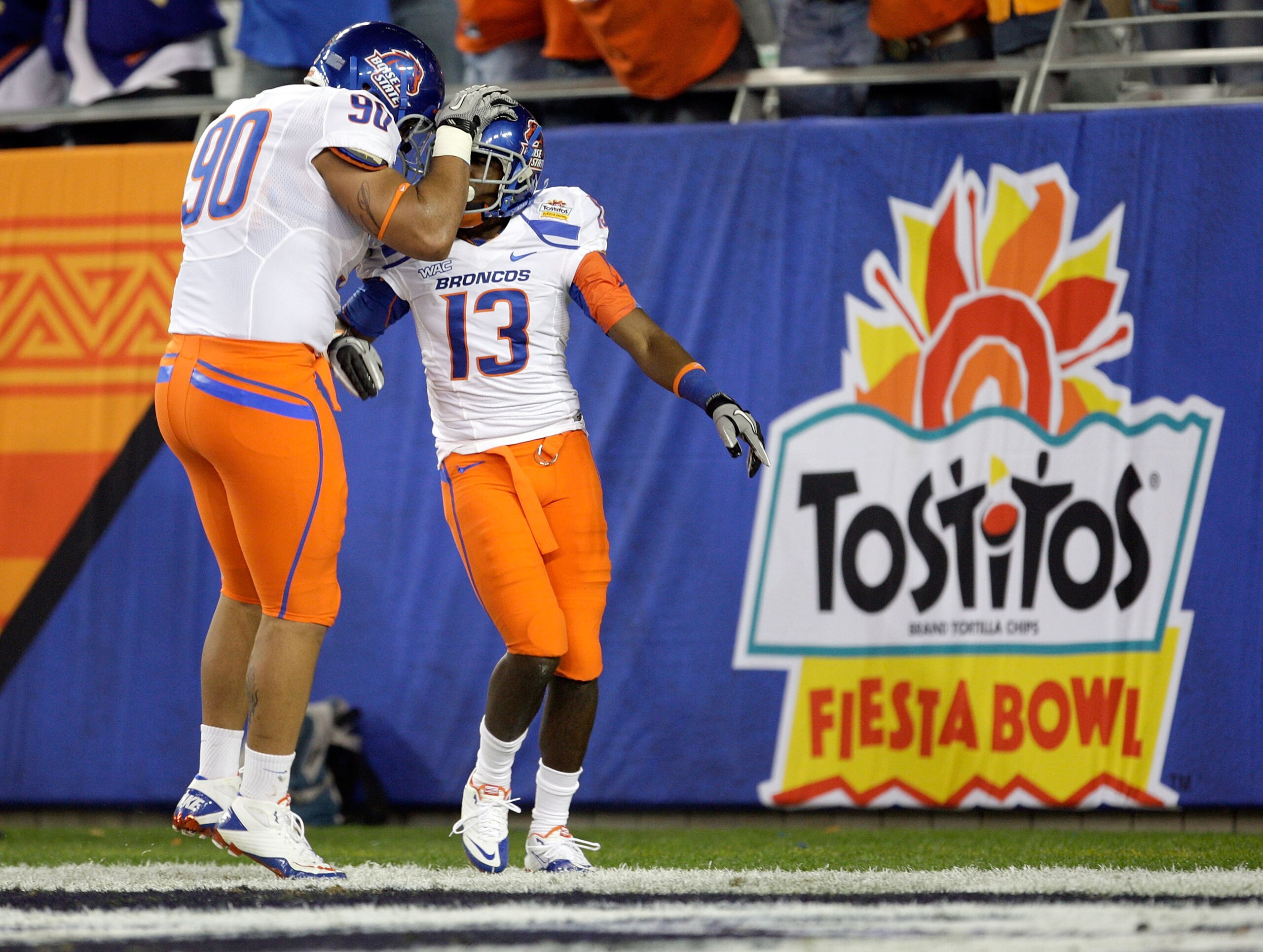 GLENDALE, AZ - JANUARY 04:  (R-L) Brandyn Thompson #13 of the Boise State Broncos celebrates with teammate Billy Winn #90 after Thompson's 50-yard interception return for a touchdown in the first quarter against the TCU Horned Frogs during the Tostitos Fi