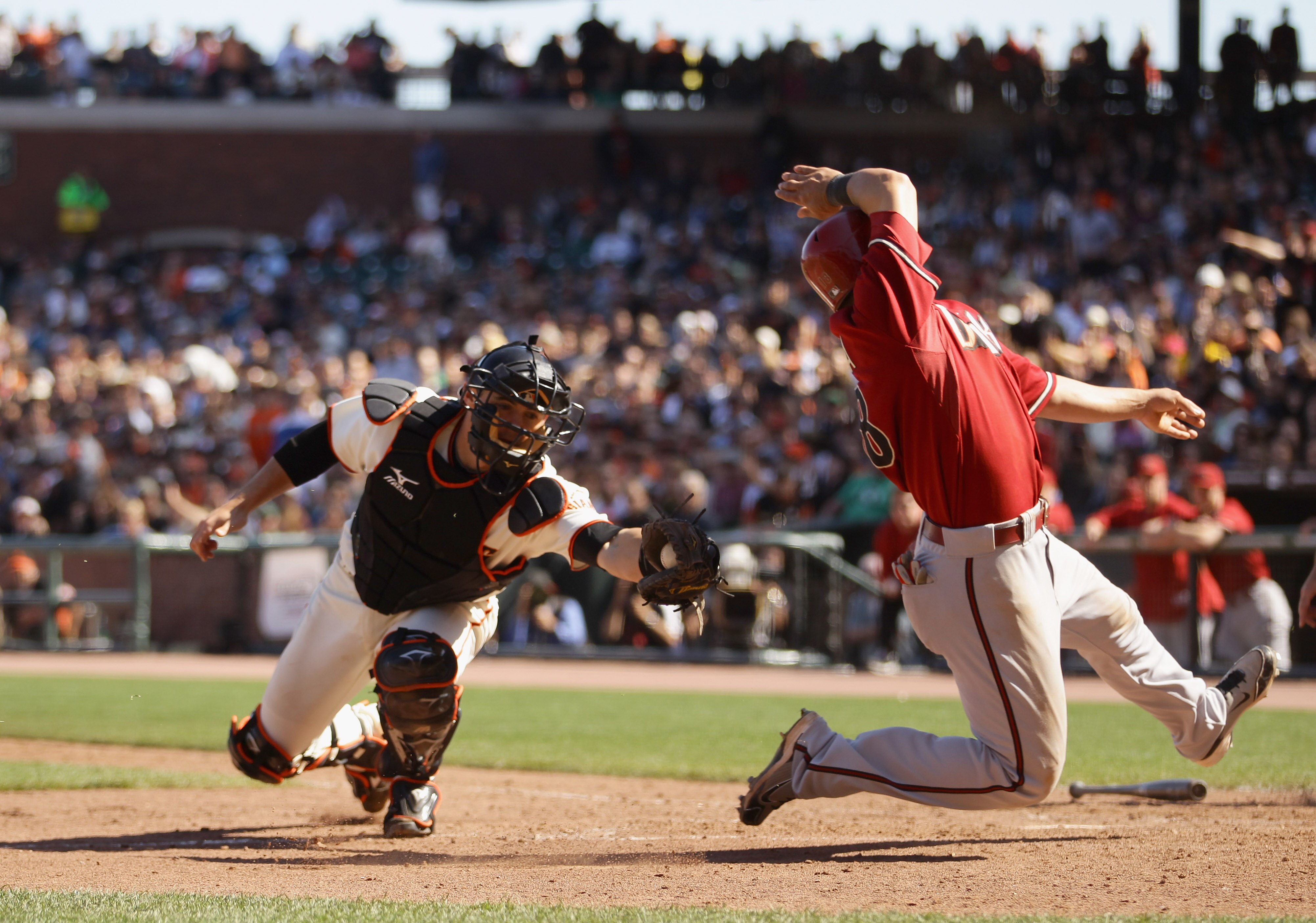 SAN FRANCISCO - AUGUST 29:  Gerardo Parra #18 of the Arizona Diamondbacks safely gets around the tag of Eli Whiteside #22 of the San Francisco Giants in the eighth inning at AT&T Park on August 29, 2010 in San Francisco, California. Parra slide past home