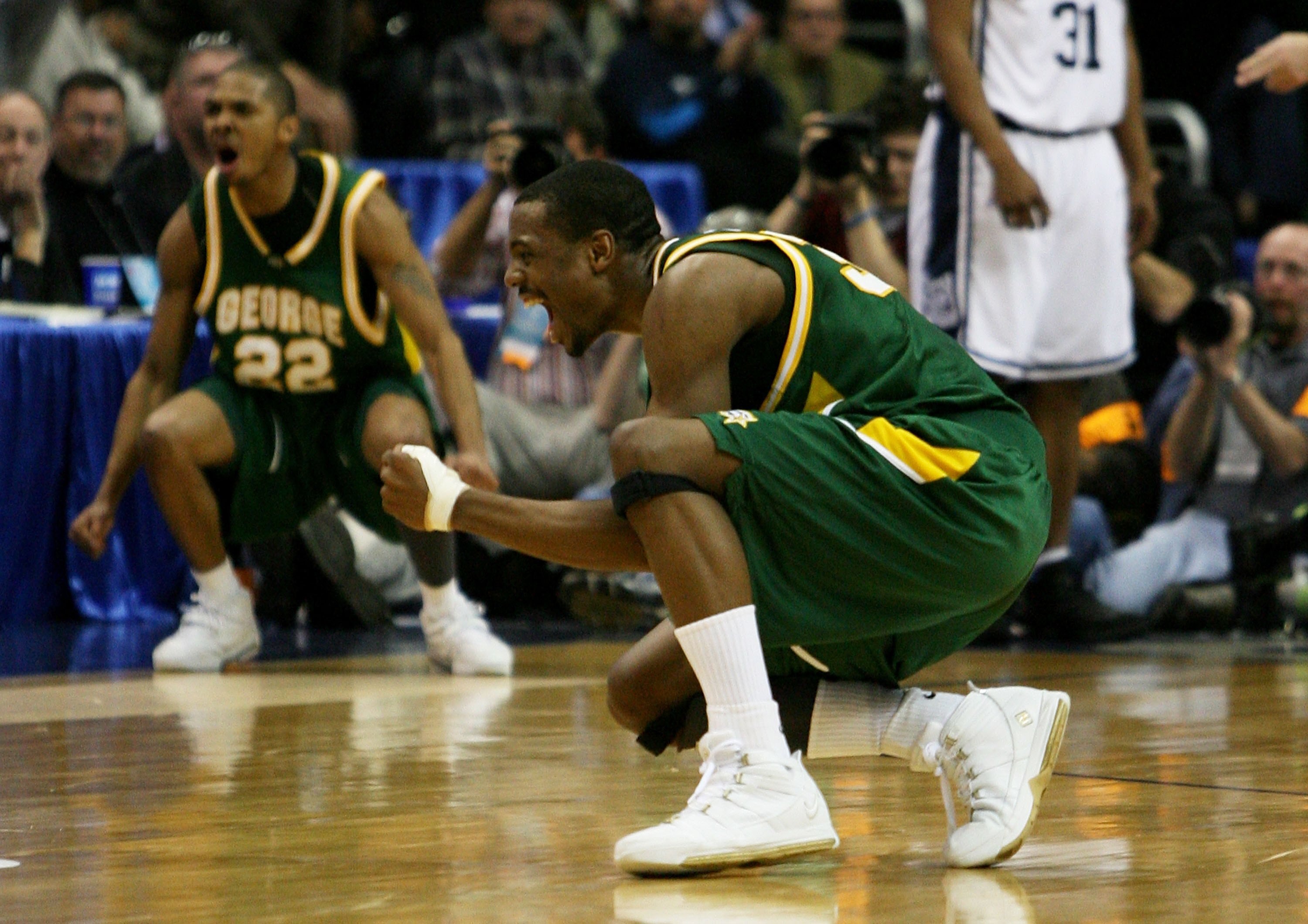 WASHINGTON - MARCH 26:  Will Thomas #34 (R) and Lamar Butler #22 of the George Washington Patriots celebrate Thomas' three-pointer late in the second half against the Connecticut Huskies during the Regional Finals of the NCAA Men's Basketball Tournament o