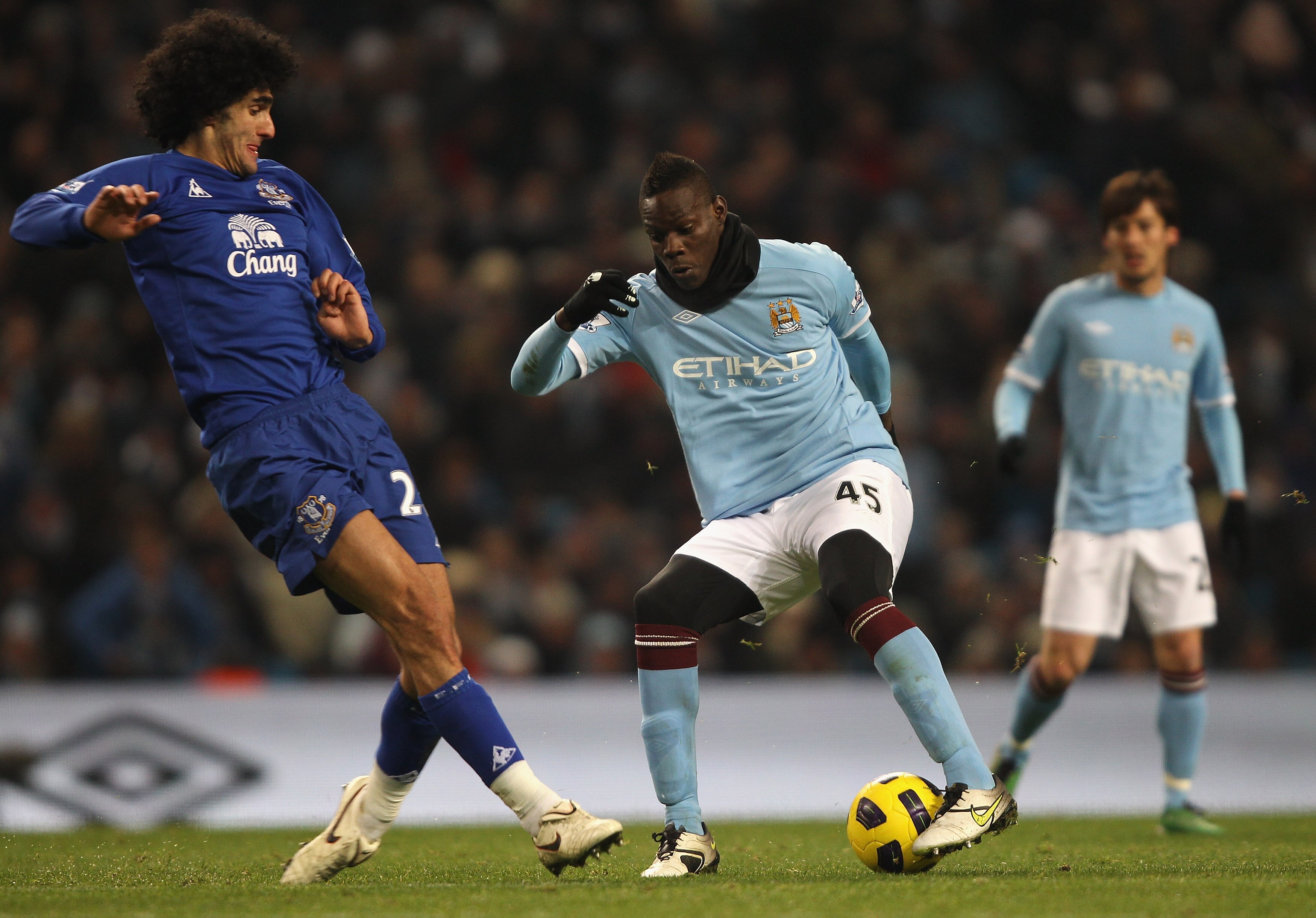 MANCHESTER, ENGLAND - DECEMBER 20: Mario Balotelli of Manchester City attempts to move around Marouane Fellaini of Everton during the Barclays Premier League match between Manchester City and Everton at City of Manchester Stadium on December 20, 2010 in M