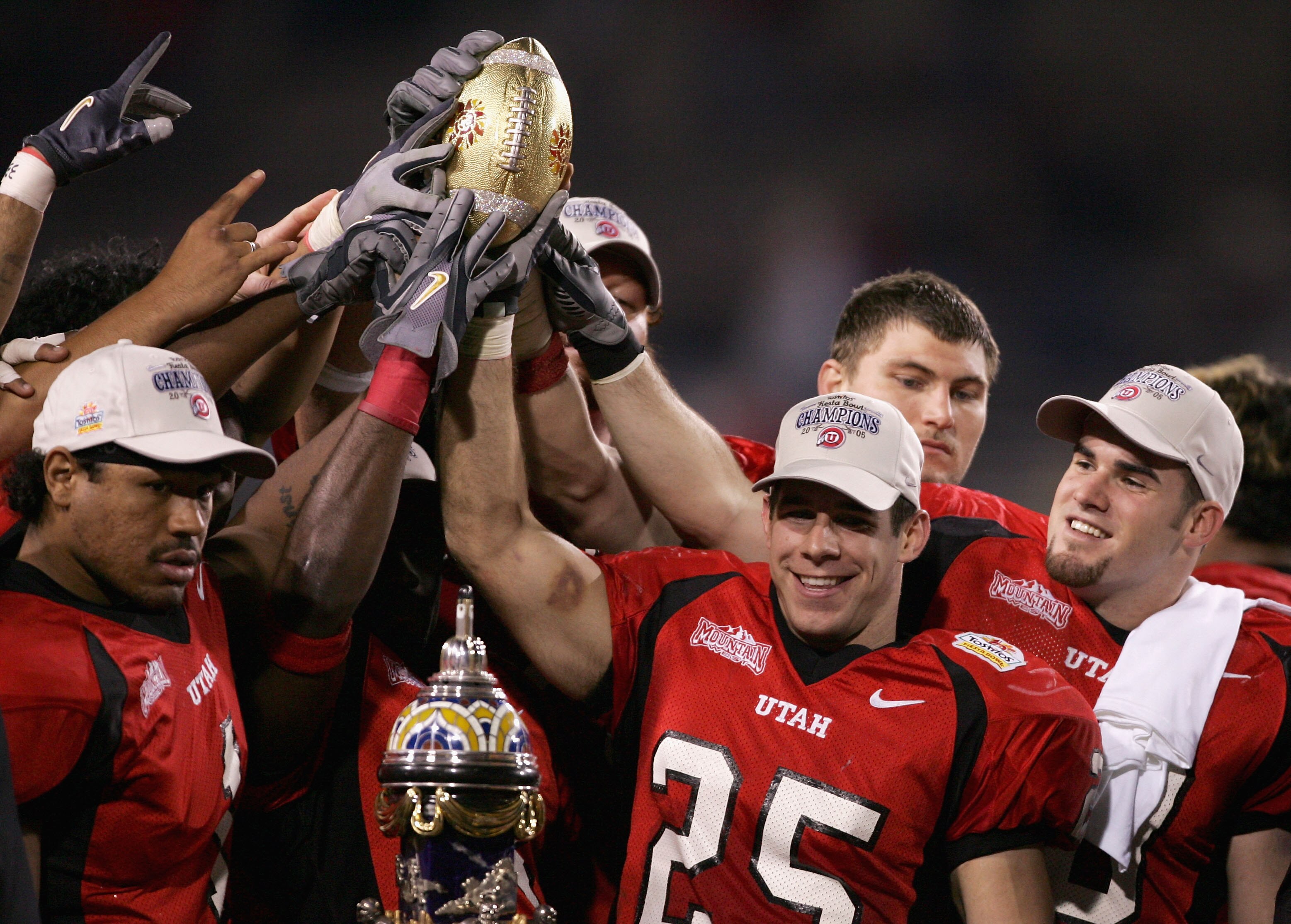 TEMPE, AZ - JANUARY 1:  Defensive back Morgan Scalley #25 of Utah holds the trophy with his team after defeating Pittsburgh 35-7 in the Tostito's Fiesta Bowl at the Sun Devil Stadium on January 1, 2005 in Tempe, Arizona.  (Photo by Harry How/Getty Images)
