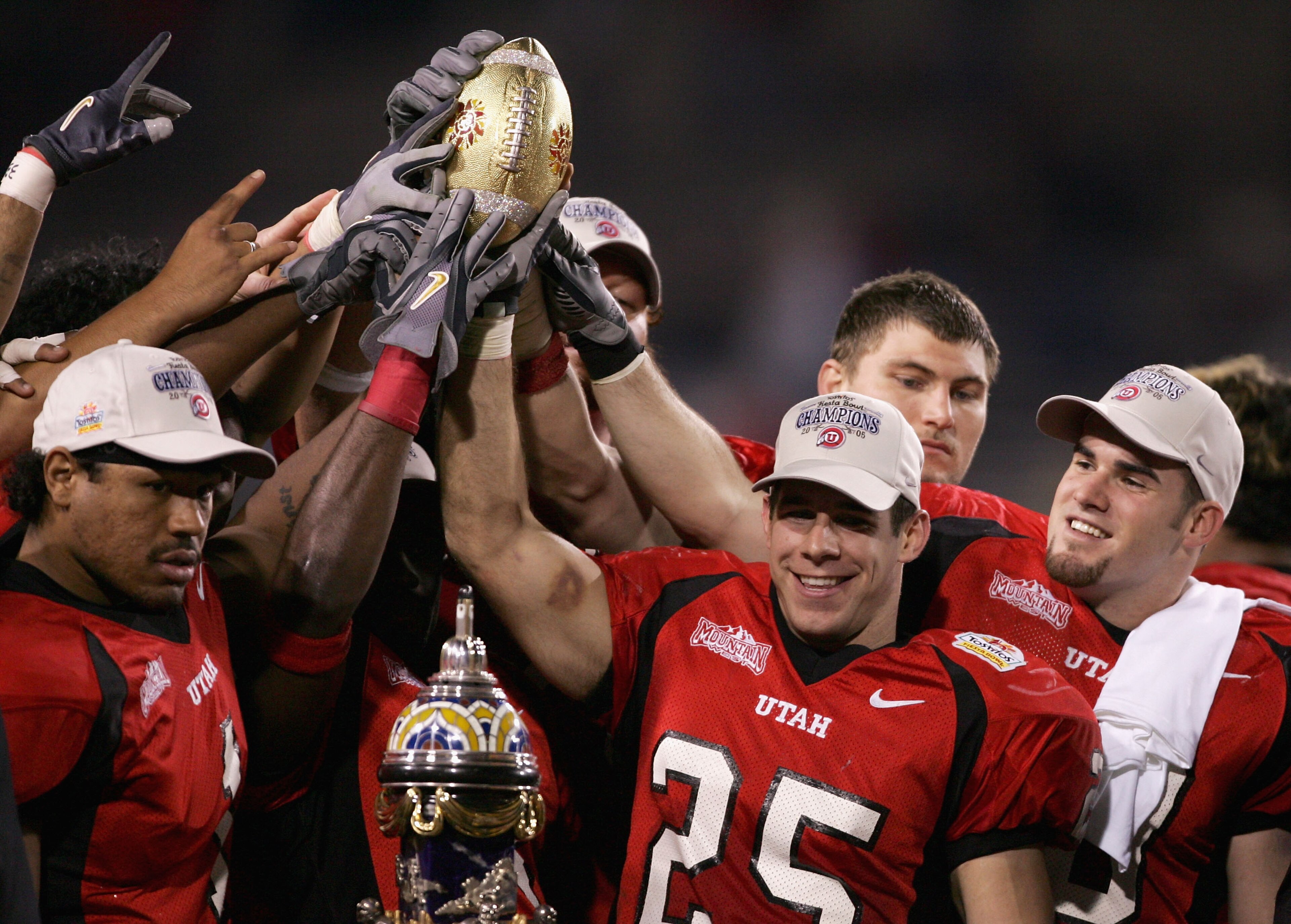 TEMPE, AZ - JANUARY 1:  Defensive back Morgan Scalley #25 of Utah holds the trophy with his team after defeating Pittsburgh 35-7 in the Tostito's Fiesta Bowl at the Sun Devil Stadium on January 1, 2005 in Tempe, Arizona.  (Photo by Harry How/Getty Images)