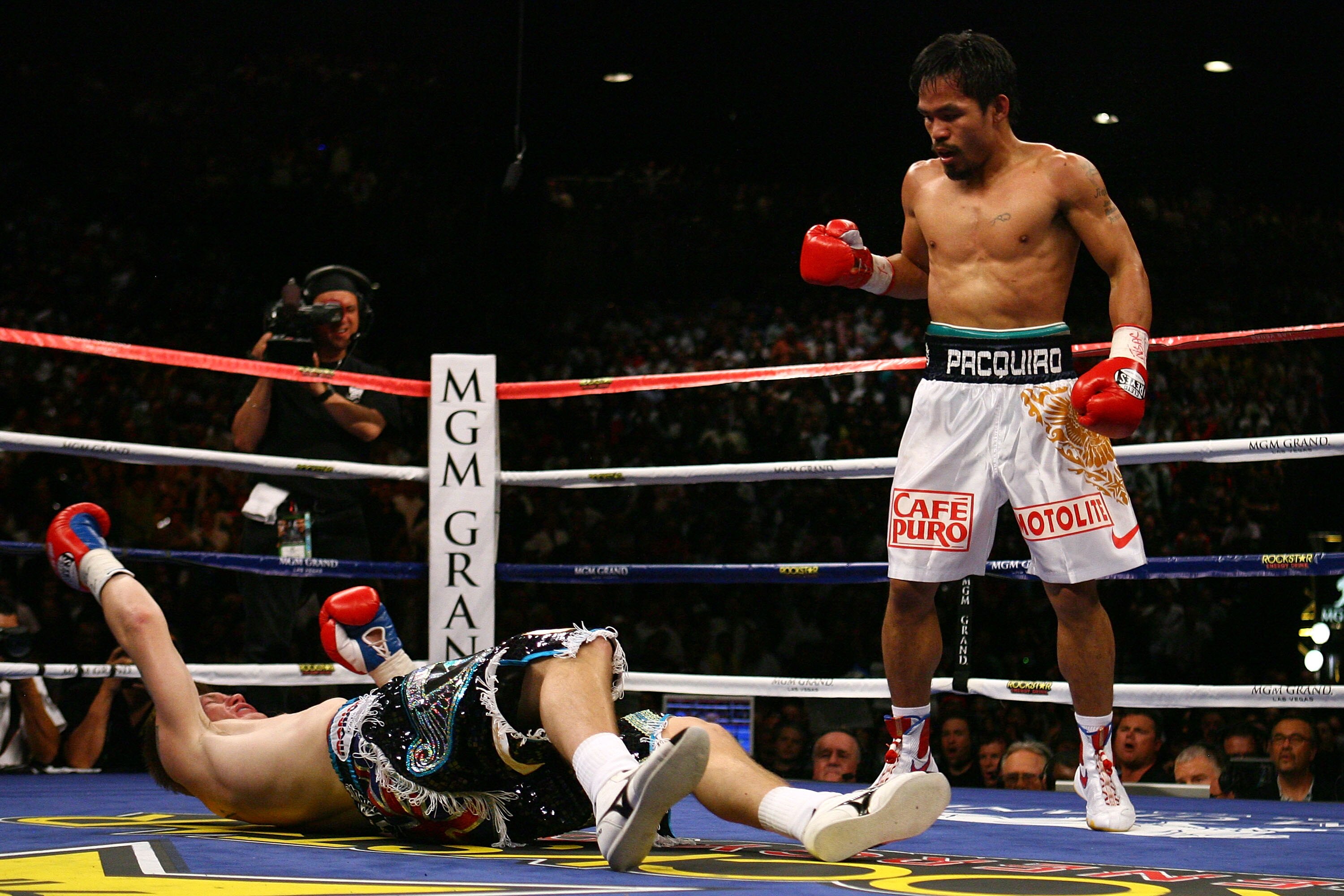 LAS VEGAS - MAY 02:  (R-L) Manny Pacquiao of the Philippines stands over Ricky Hatton of England after Pacquiao knocked him out in the second round during their junior welterweight title fight at the MGM Grand Garden Arena May 2, 2009 in Las Vegas, Nevada