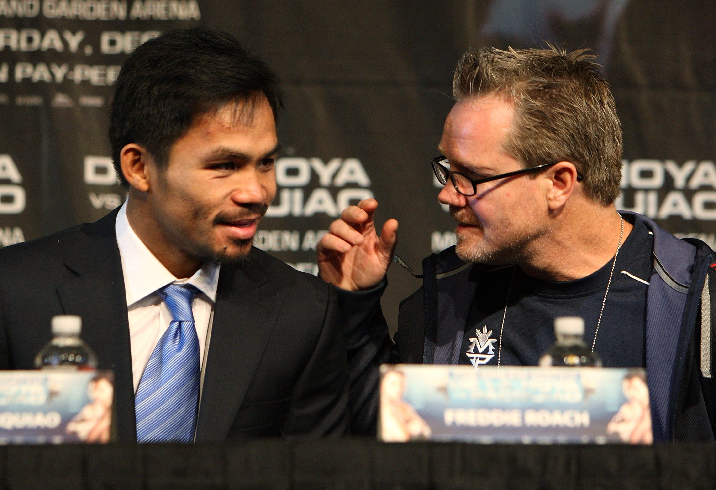 LAS VEGAS - DECEMBER 3:  Boxer Manny Pacquiao (L) of the Philippines speaks with his trainer Freddie Roach at the final press conference at the MGM Grand Garden Arena December 3, 2008 in Las Vegas, Nevada. Boxer Oscar de la Hoya fights Manny Pacquiao Dece