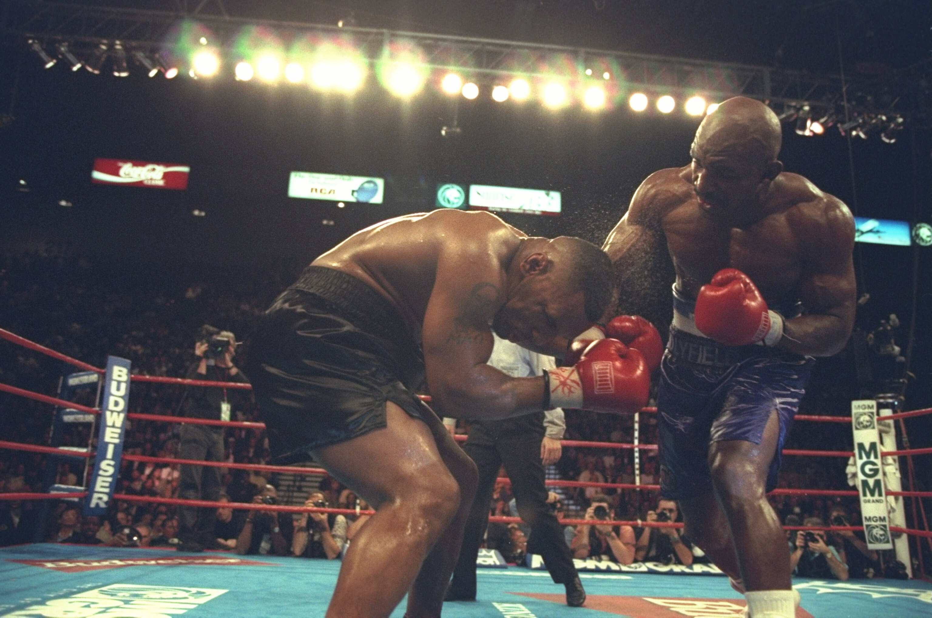 9 Nov 1996:  Mike Tyson ducks to cover his head from the punches of  Evander Holyfield before losing by TKO in the 11th round at the MGM Grand Garden in Las Vegas, Nevada. Mandatory Credit: Al Bello  /Allsport