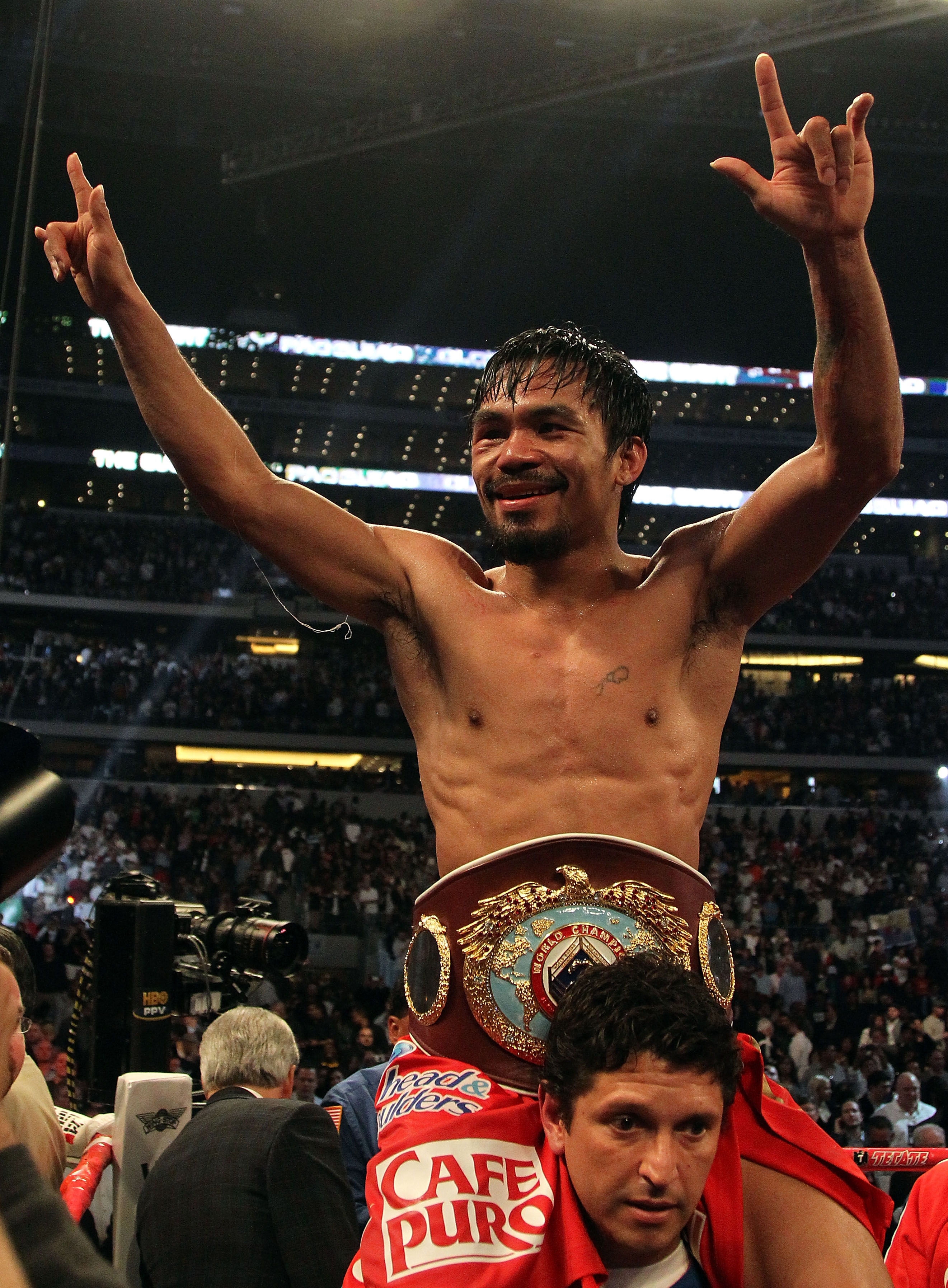 ARLINGTON, TX - MARCH 13:  Manny Pacquiao of the Philippines celebrates in the ring after defeating Joshua Clottey of Ghana during the WBO welterweight title fight at Cowboys Stadium on March 13, 2010 in Arlington, Texas. Pacquiao defeated Clottey by unan