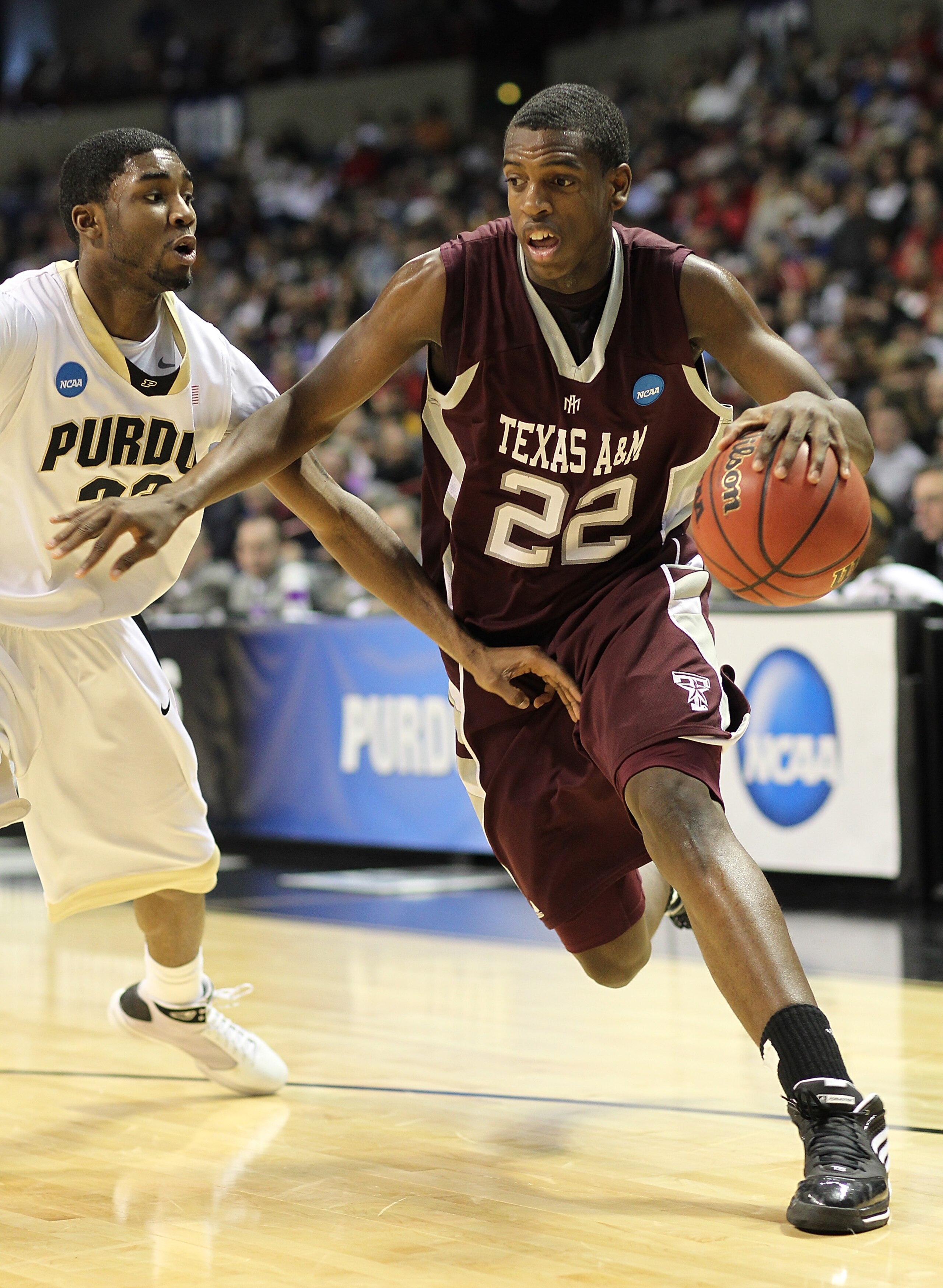SPOKANE, WA - MARCH 21: Khris Middleton #22 of the Texas A&M Aggies drives against E'Twaun Moore #33 of the Purdue Boilermakers during the second round of the 2010 NCAA men's basketball tournament at the Spokane Arena on March 21, 2010 in Spokane, Washi SPOKANE, WA - MARCH 21: Khris Middleton #22 of the Texas A&M Aggies drives against E'Twaun Moore #33 of the Purdue Boilermakers during the second round of the 2010 NCAA men's basketball tournament at the Spokane Arena on March 21, 2010 in Spokane, Washi