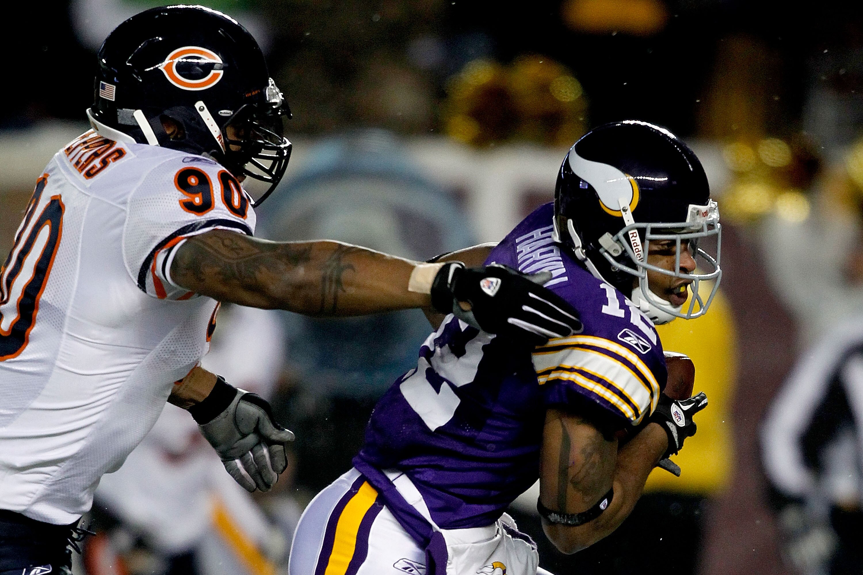 MINNEAPOLIS, MN - DECEMBER 20:  Percy Harvin #12 of the Minnesota Vikings of the Minnesota Vikings slips out of the grasp of Julius Peppers #90 of the Chicago Bears  for a touchdown at TCF Bank Stadium on December 20, 2010 in Minneapolis, Minnesota.  (Pho