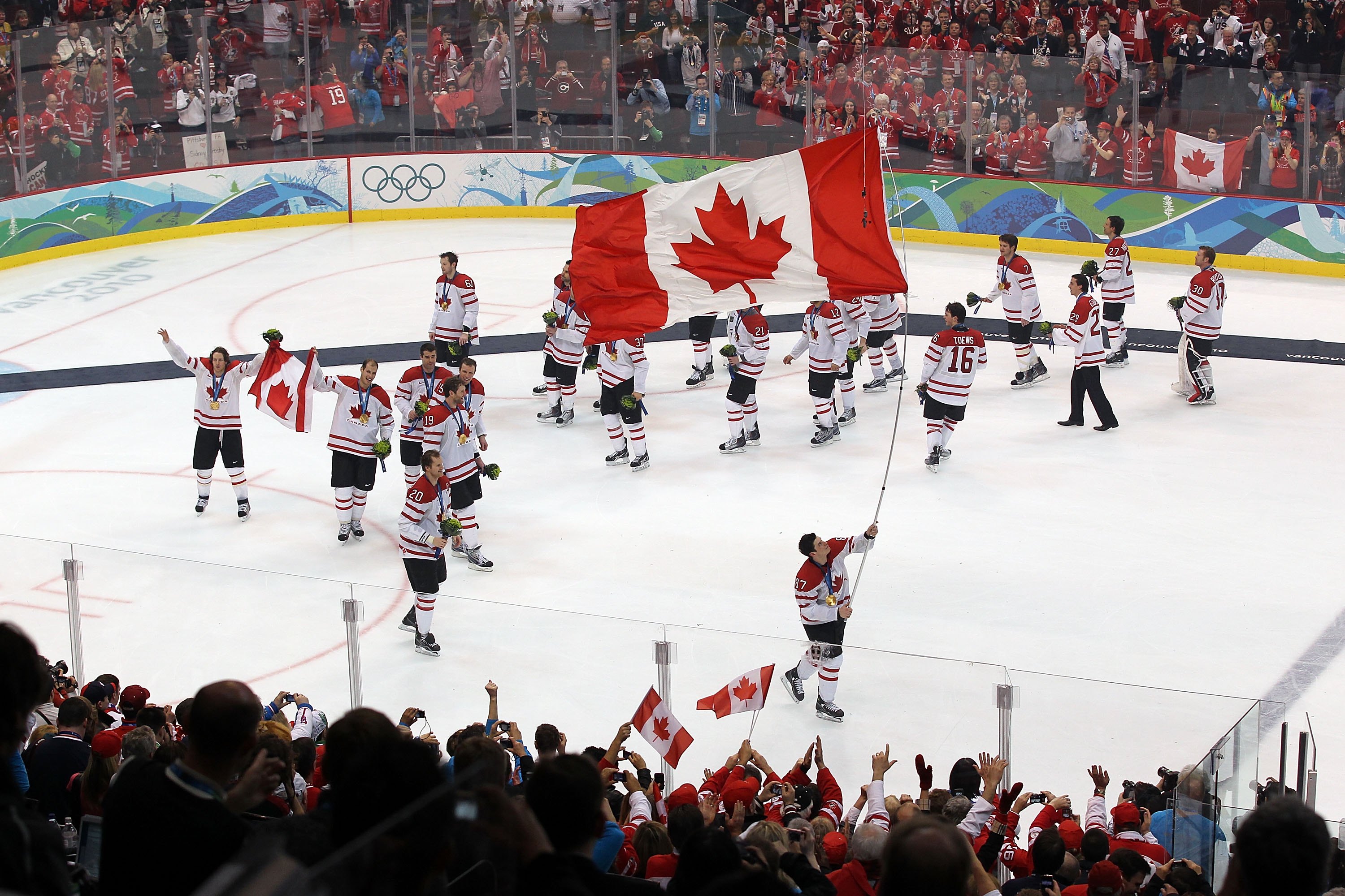 VANCOUVER, BC - FEBRUARY 28:  Sidney Crosby #87 of Canada skates with the Canadian national flag following Canada's 3-2 overtime victory during the ice hockey men's gold medal game between USA and Canada on day 17 of the Vancouver 2010 Winter Olympics at
