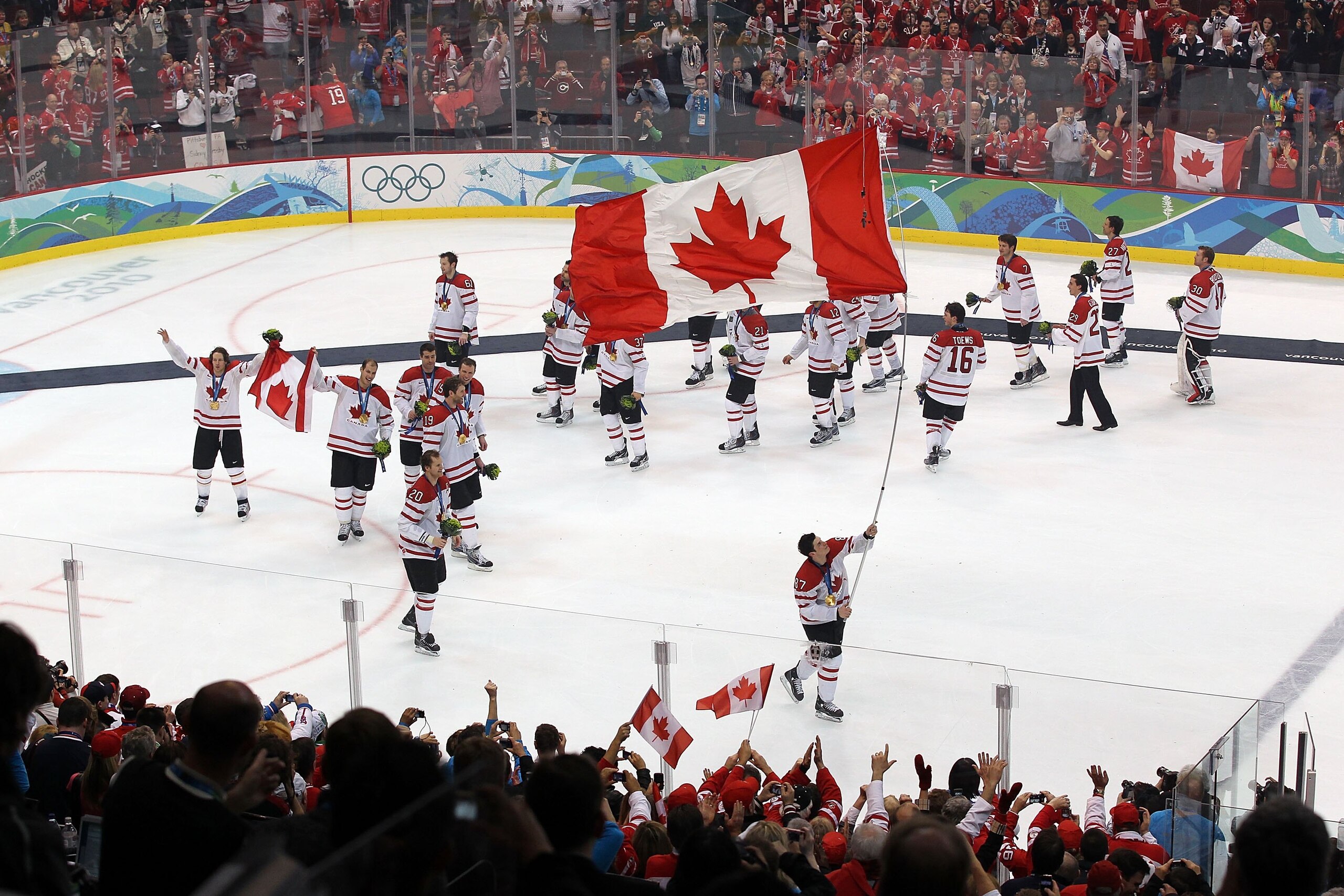 VANCOUVER, BC - FEBRUARY 28:  Sidney Crosby #87 of Canada skates with the Canadian national flag following Canada's 3-2 overtime victory during the ice hockey men's gold medal game between USA and Canada on day 17 of the Vancouver 2010 Winter Olympics at