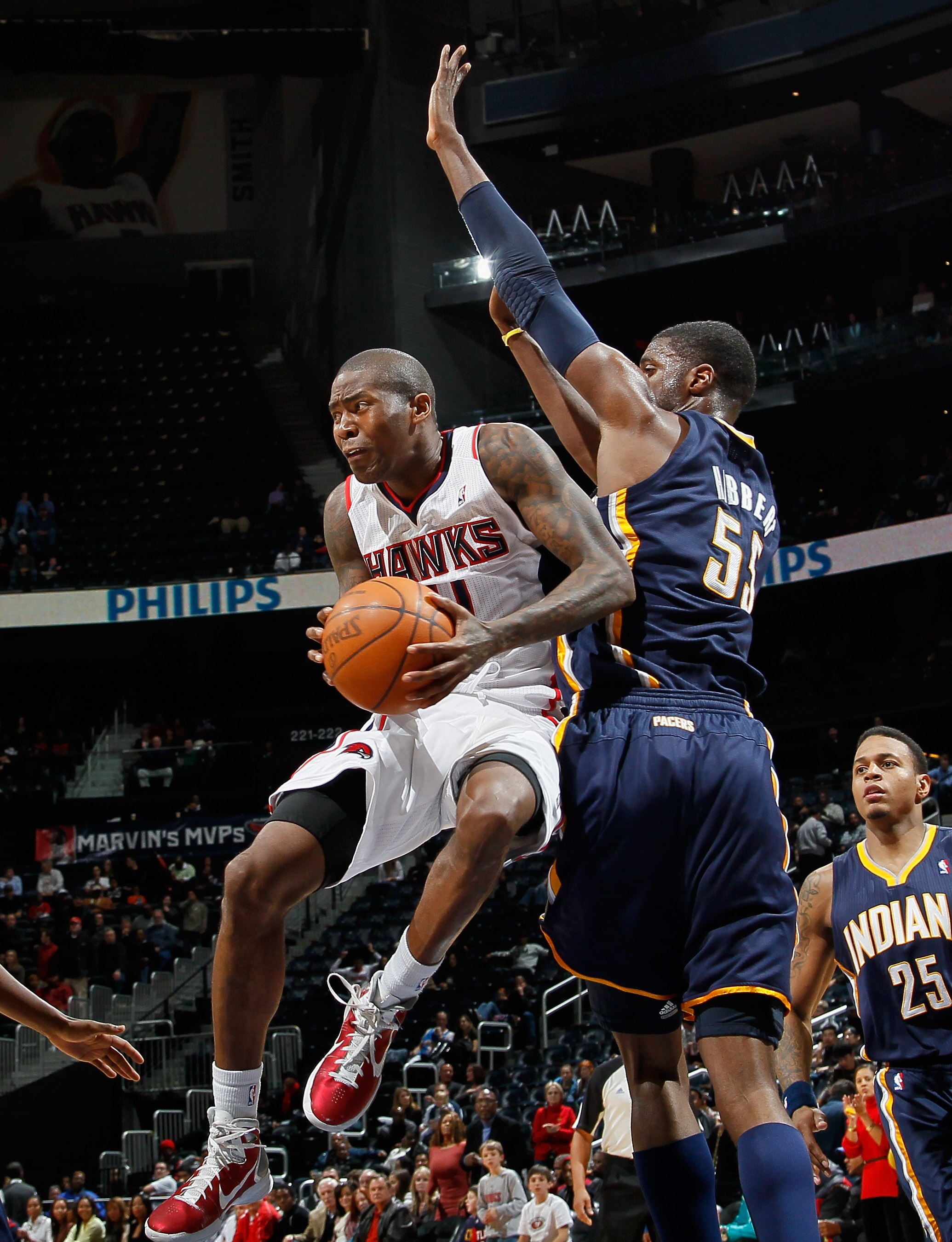 ATLANTA, GA - DECEMBER 11:  Jamal Crawford #11 of the Atlanta Hawks drives against Roy Hibbert #55 of the Indiana Pacers at Philips Arena on December 11, 2010 in Atlanta, Georgia.  NOTE TO USER: User expressly acknowledges and agrees that, by downloading