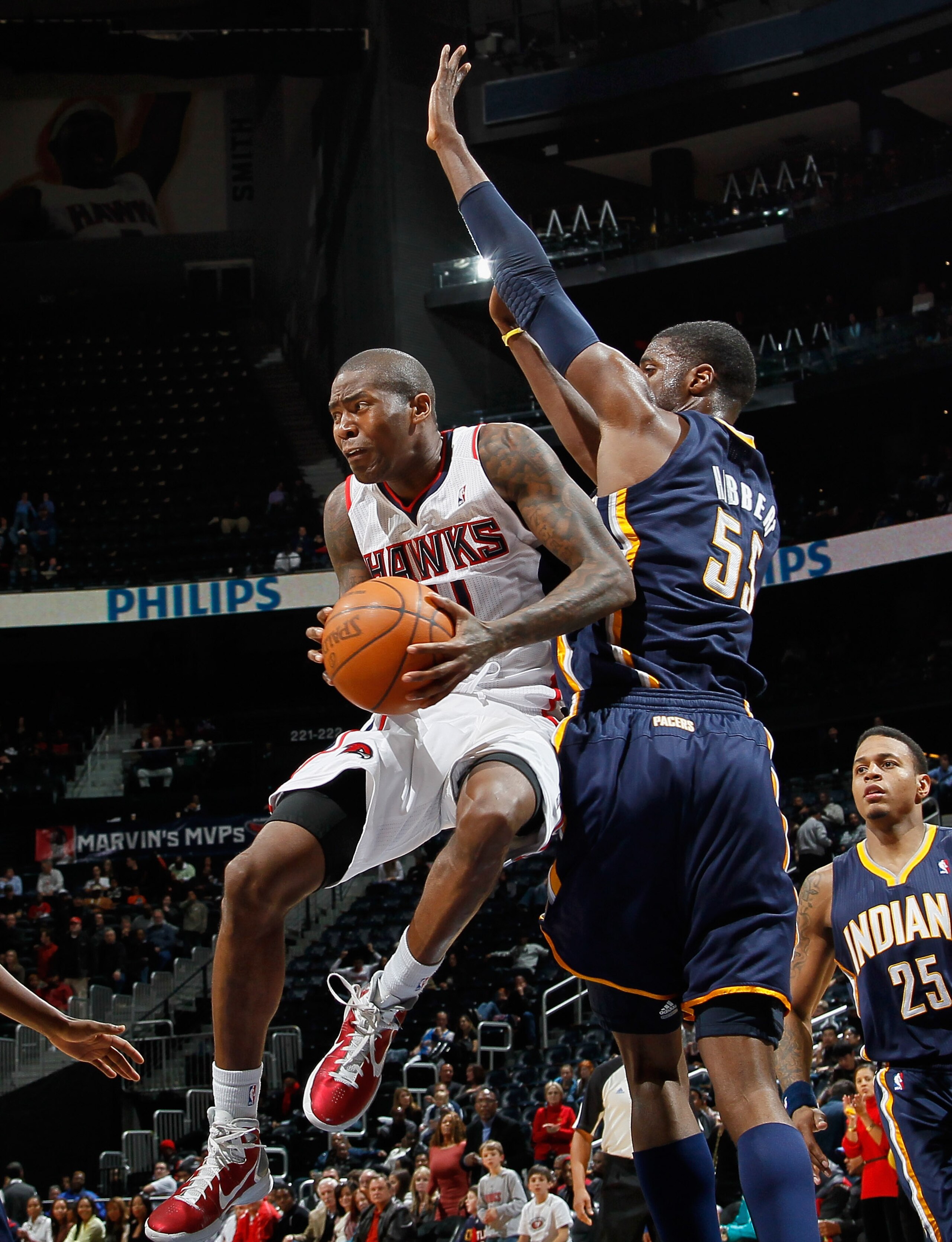 ATLANTA, GA - DECEMBER 11:  Jamal Crawford #11 of the Atlanta Hawks drives against Roy Hibbert #55 of the Indiana Pacers at Philips Arena on December 11, 2010 in Atlanta, Georgia.  NOTE TO USER: User expressly acknowledges and agrees that, by downloading