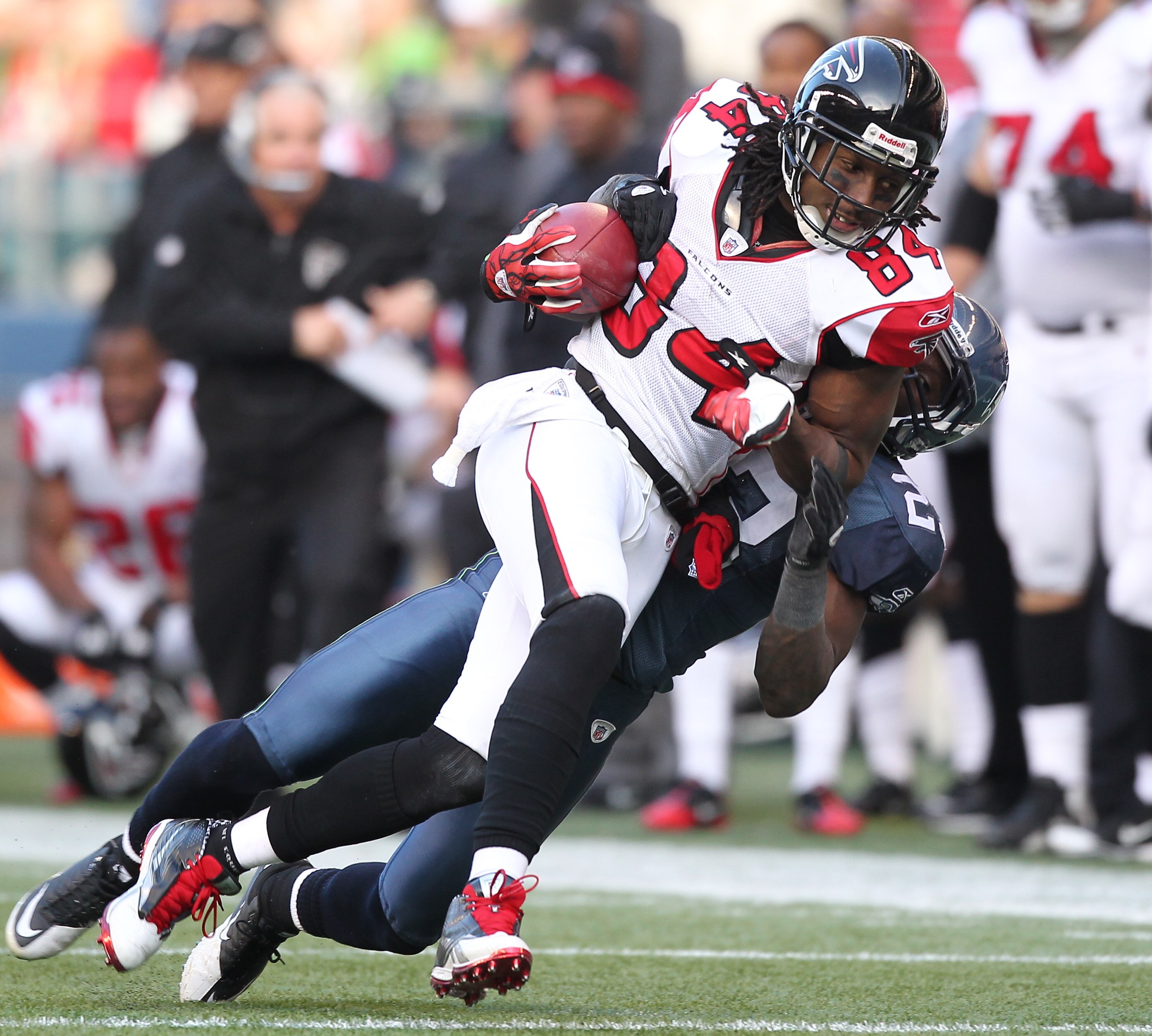 SEATTLE, WA - DECEMBER 19:  Wide receiver Roddy White #84 of the Atlanta Falcons rushes against Marcus Trufant #23 of the Seattle Seahawks at Qwest Field on December 19, 2010 in Seattle, Washington. (Photo by Otto Greule Jr/Getty Images)