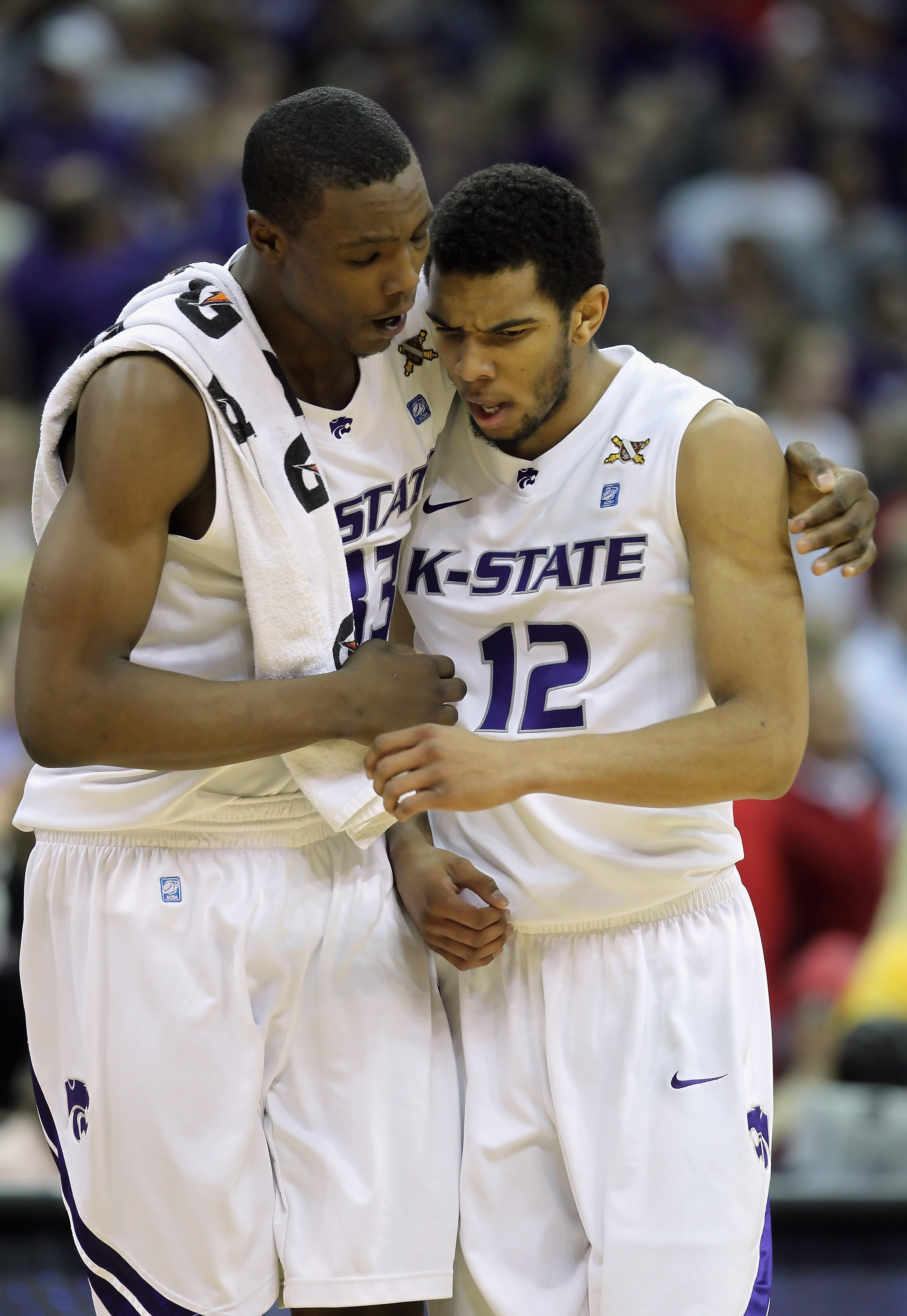 KANSAS CITY, MO - DECEMBER 21:  Nick Russell #12 of the Kansas State Wildcats is hugged by Wally Judge #33 during the game against the UNLV Rebels on December 21, 2010 at the Sprint Center in Kansas City, Missouri.  (Photo by Jamie Squire/Getty Images)