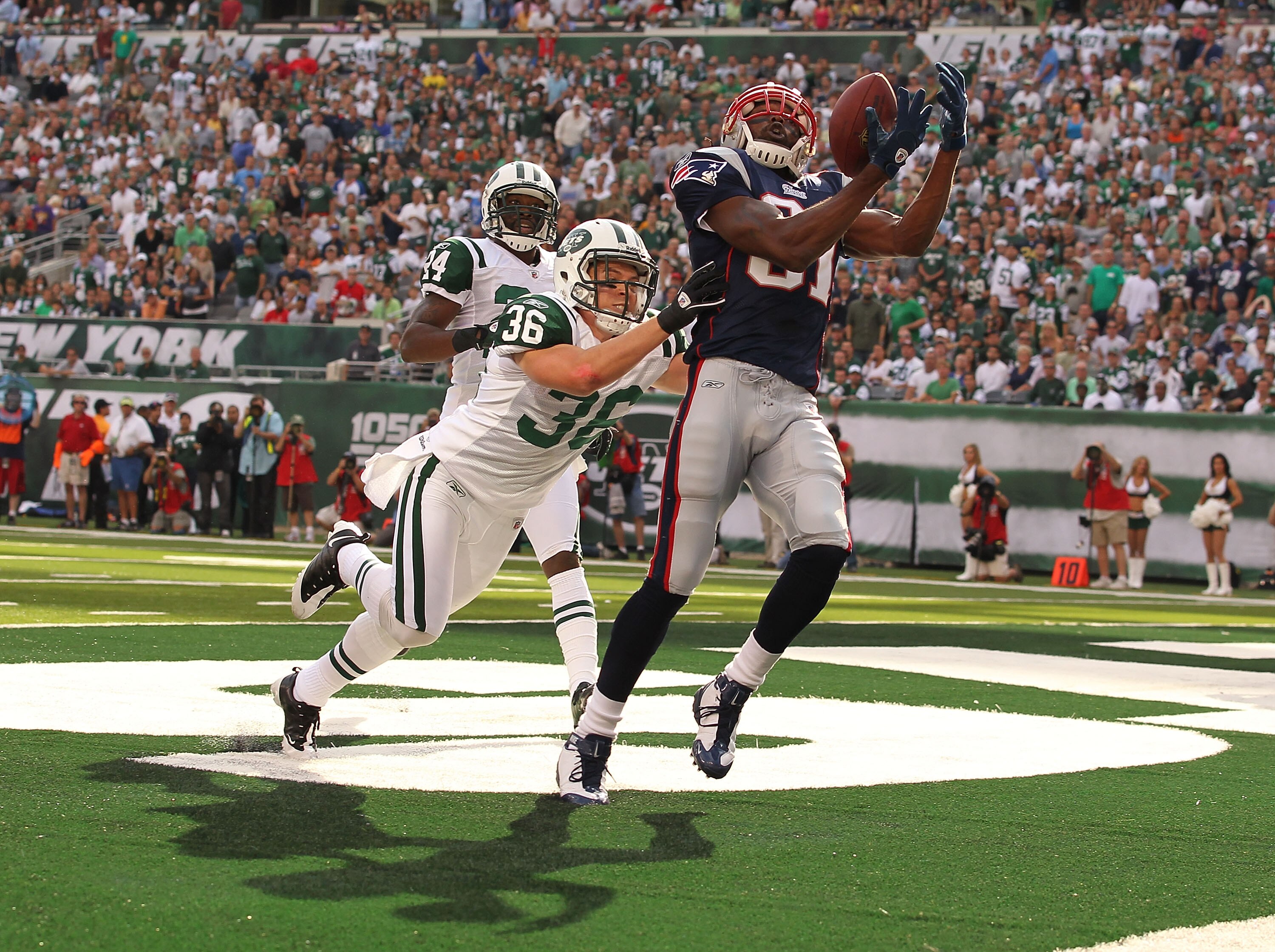 EAST RUTHERFORD, NJ - SEPTEMBER 19:  Jim Leonhard #36 of the New York Jets defends against Randy Moss #81 of the New England Patriots on September 19, 2010 at the New Meadowlands Stadium  in East Rutherford, New Jersey. There was no touchdown on the play.