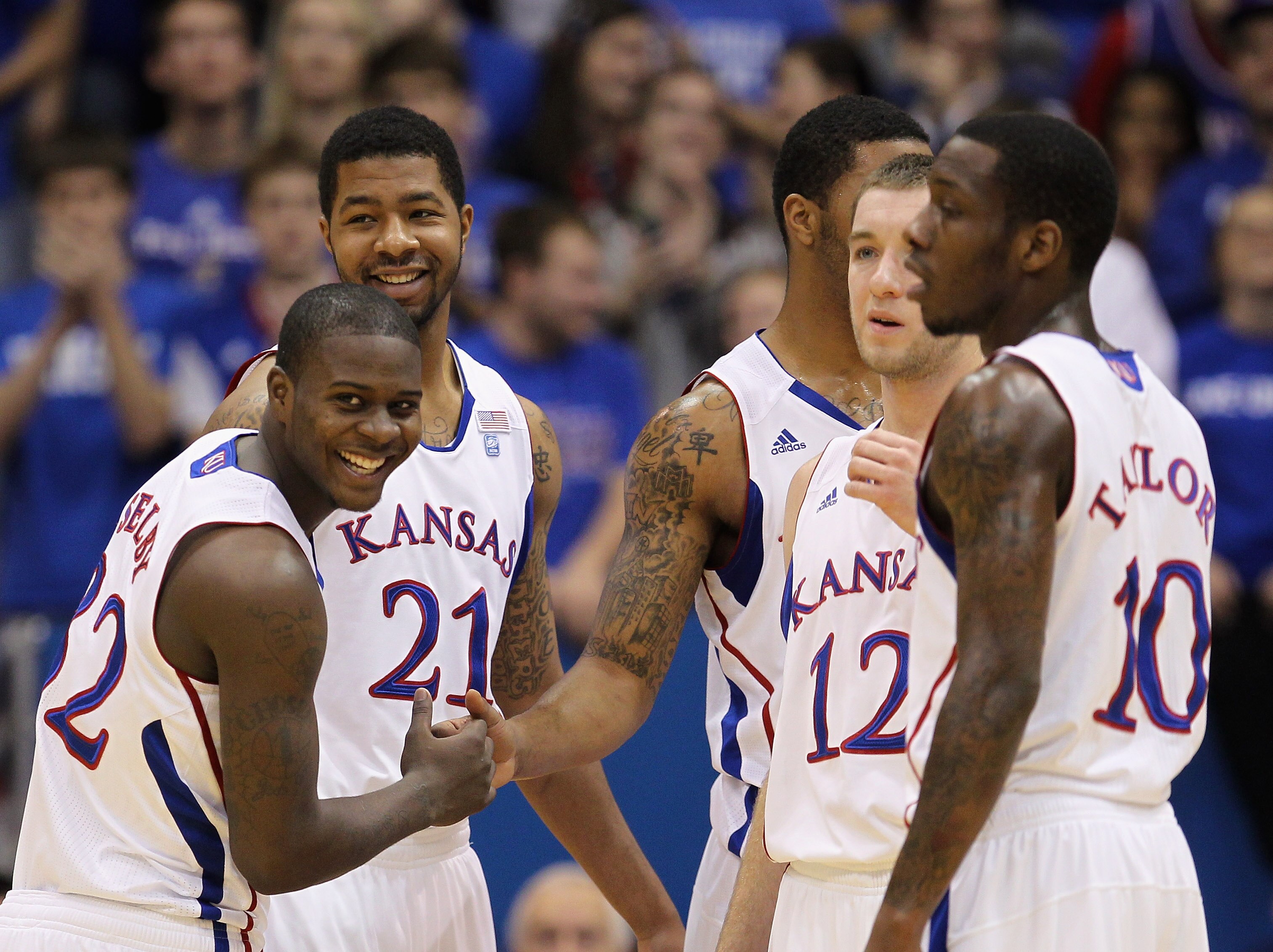 LAWRENCE, KS - DECEMBER 18:  Josh Selby #32 of the Kansas Jayhawks jokes with teammates prior to the start of the game against the USC Trojans on December 18, 2010 at Allen Fieldhouse in Lawrence, Kansas.  (Photo by Jamie Squire/Getty Images)