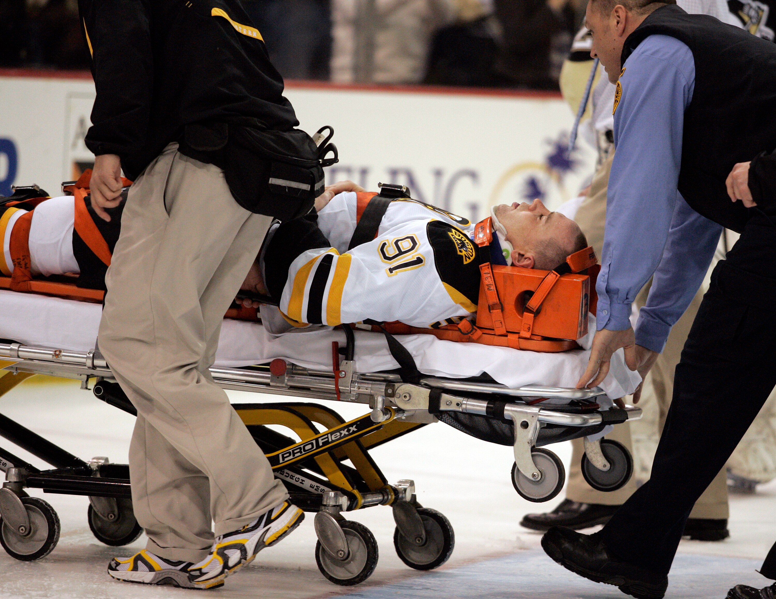 PITTSBURGH, PA - MARCH 07:  Marc Savard #91 of the Boston Bruins is taken off the ice by medical staff after being injured in the third period against the Pittsburgh Penguins at Mellon Arena on March 7, 2010 in Pittsburgh, Pennsylvania.  The Penguins defe