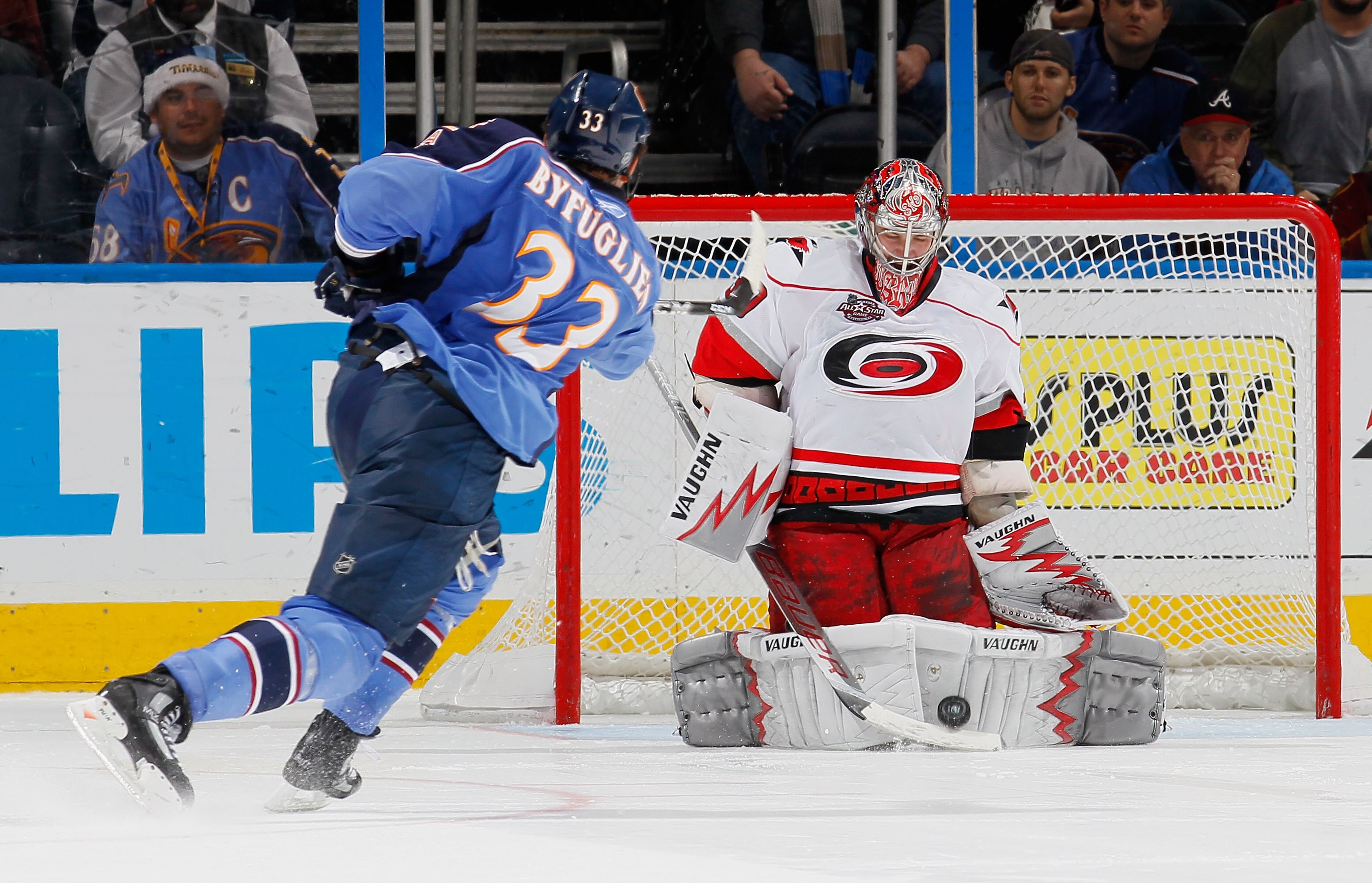 ATLANTA, GA - DECEMBER 16:  Goaltender Cam Ward #30 of the Carolina Hurricanes saves a shot by Dustin Byfuglien #33 of the Atlanta Thrashers during a shootout at Philips Arena on December 16, 2010 in Atlanta, Georgia.  (Photo by Kevin C. Cox/Getty Images)