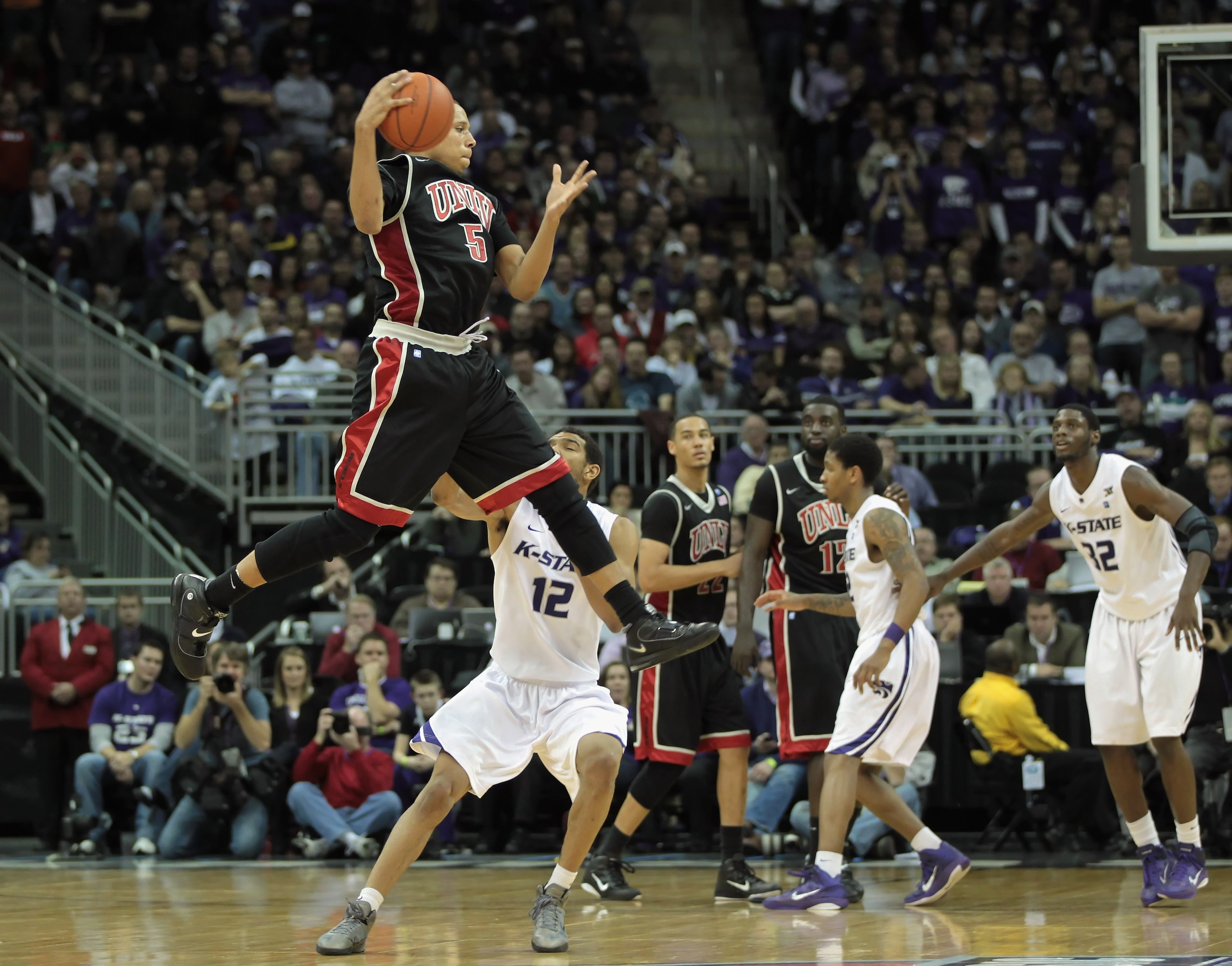 KANSAS CITY, MO - DECEMBER 21:  Derrick Jasper #5 of the UNLV Rebels grabs a pass against the Kansas State Wildcats during the game on December 21, 2010 at the Sprint Center in Kansas City, Missouri.  (Photo by Jamie Squire/Getty Images)