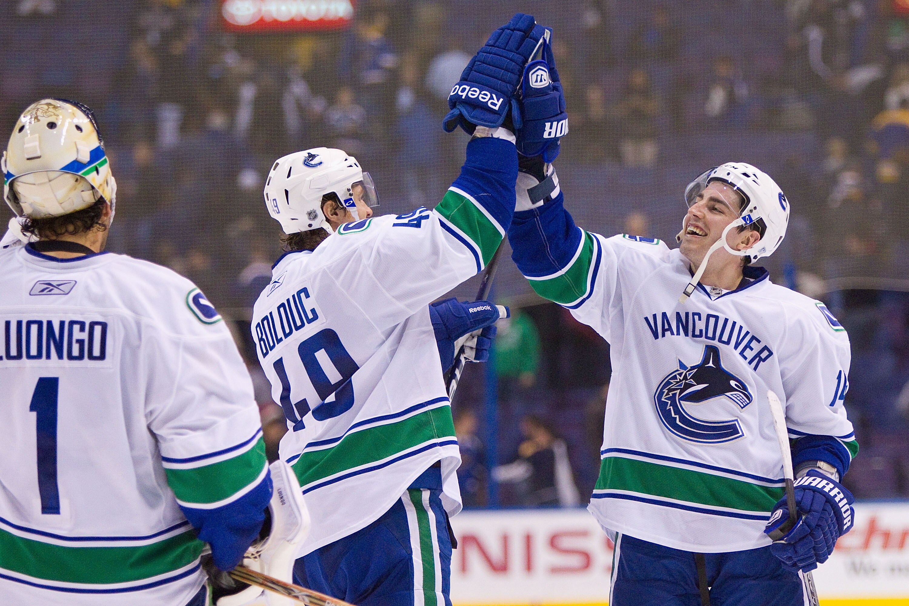 ST. LOUIS, MO - DECEMBER 20: Alex Burrows #14 and Alex Bolduc #49 both of the Vancouver Canucks celebrate a victory over St. Louis Blues at the Scottrade Center on December 20, 2010 in St. Louis, Missouri.  The Canucks beat the Blues 3-1.  (Photo by Dilip