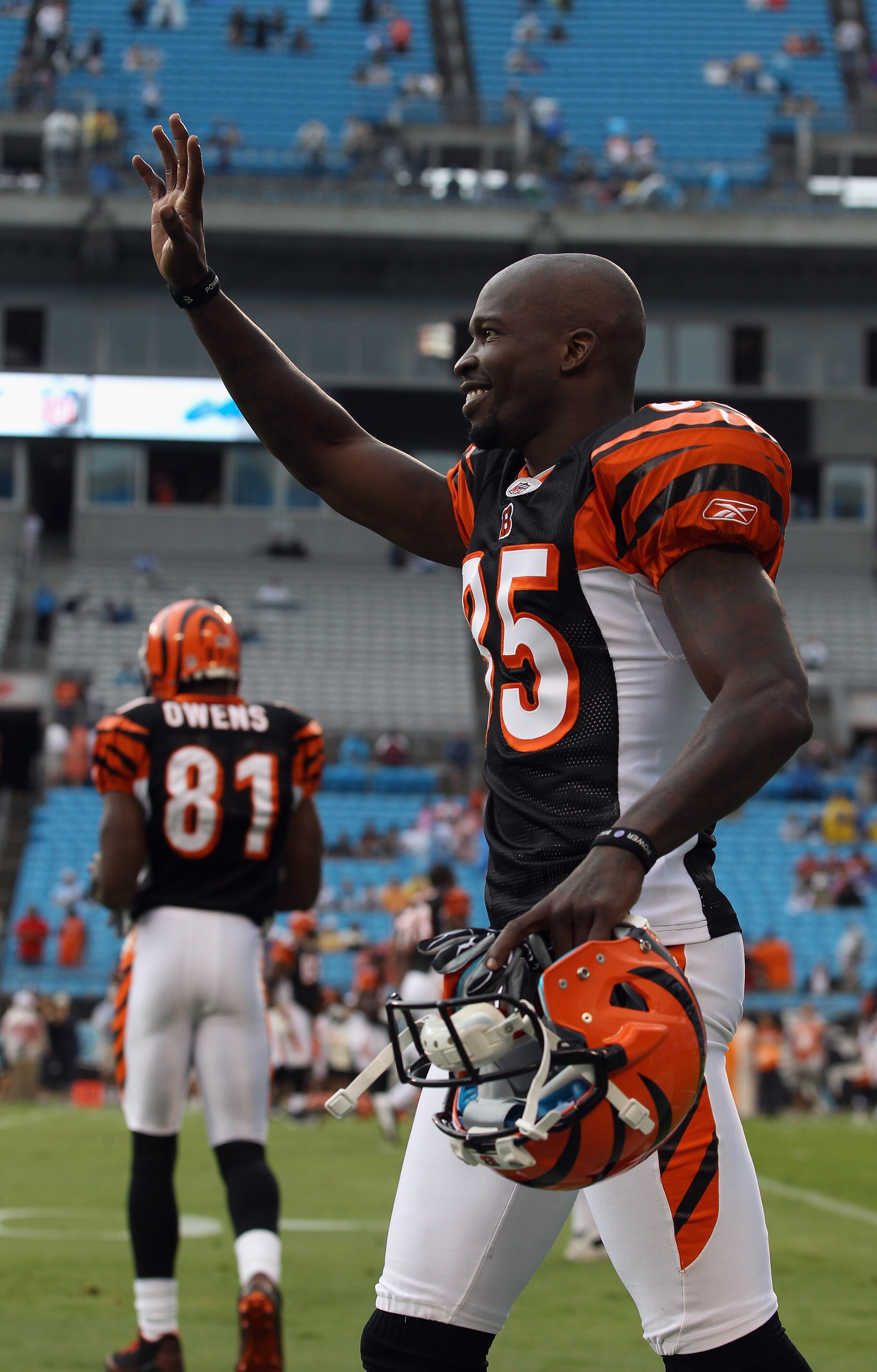 CHARLOTTE, NC - SEPTEMBER 26:  Chad Ochocinco #85 of the Cincinnati Bengals waves to the Carolina Panthers before the start of their game as teammate Terrell Owens #81 watches on at Bank of America Stadium on September 26, 2010 in Charlotte, North Carolin