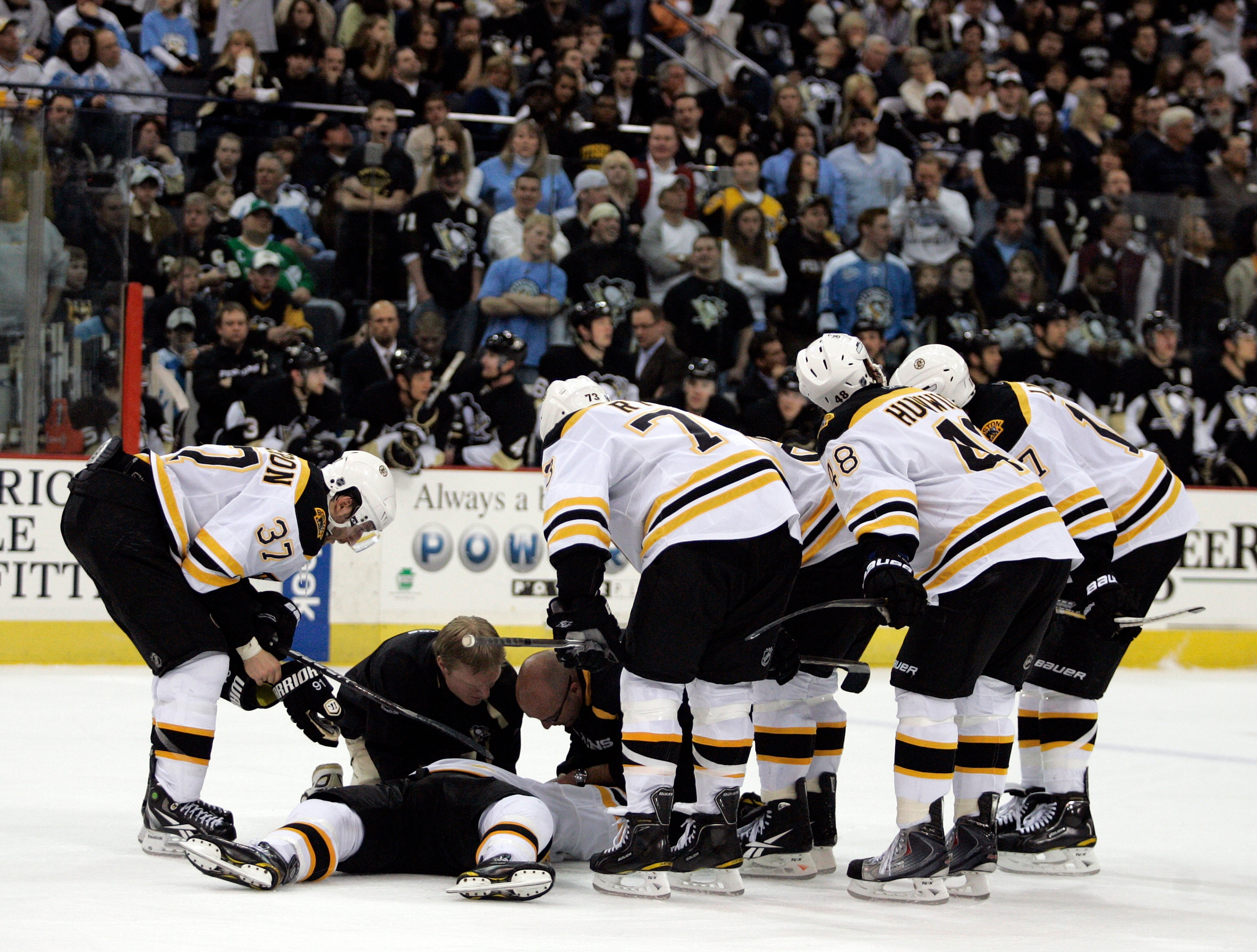 PITTSBURGH, PA - MARCH 07:  Marc Savard #91 of the Boston Bruins lies injured on the ice against the Pittsburgh Penguins in the third period at Mellon Arena on March 7, 2010 in Pittsburgh, Pennsylvania.  The Penguins defeated the Bruins 2-1.  (Photo by Ju