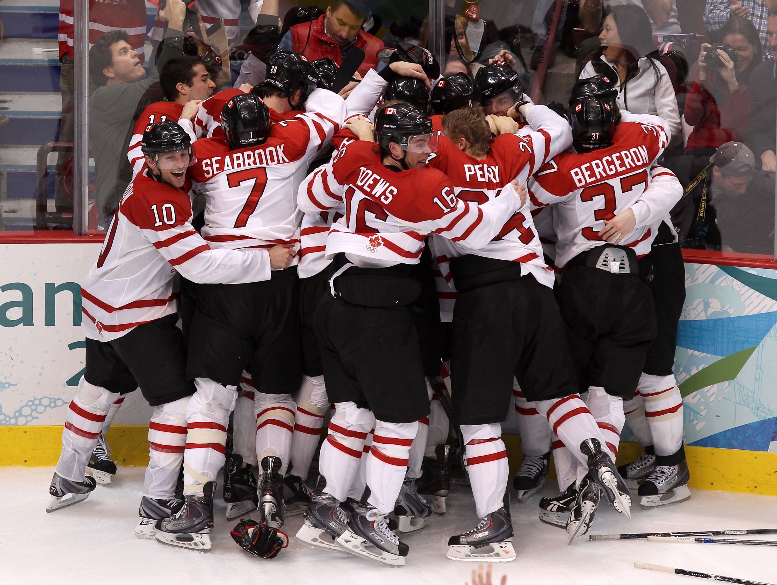 VANCOUVER, BC - FEBRUARY 28:  Team Canada celebrate after Sidney Crosby (obscured) #87 of Canada scored the match-winning goal in overtime during the ice hockey men's gold medal game between USA and Canada on day 17 of the Vancouver 2010 Winter Olympics a