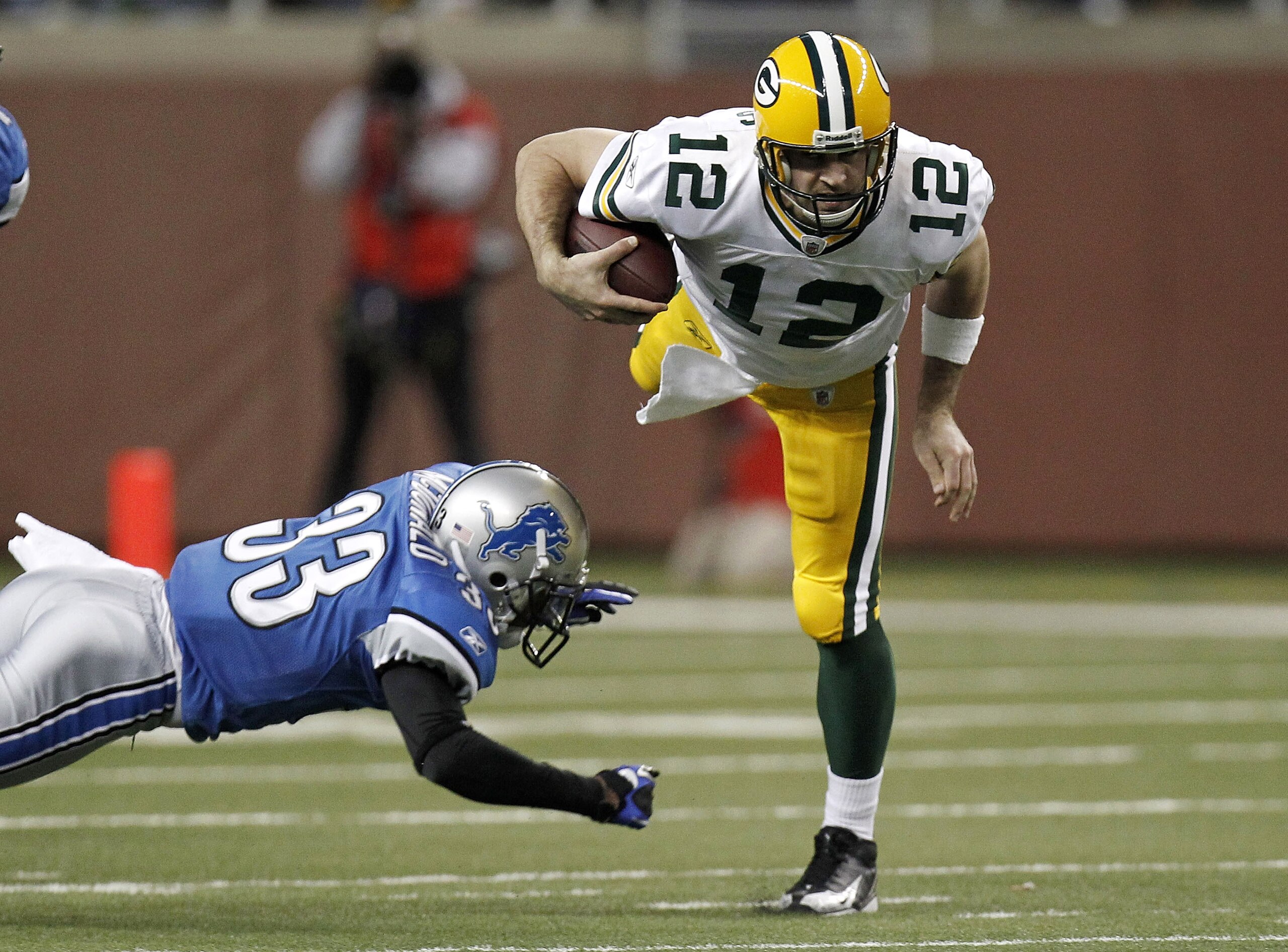 DETROIT, MI - DECEMBER 12:  Aaron Rodgers #12 of the Green Bay Packers is tackled during a second half run by Brandon McDonald #33 of the Detroit Lions on December 12, 2010 at Ford Field in Detroit, Michigan.  (Photo by Gregory Shamus/Getty Images)