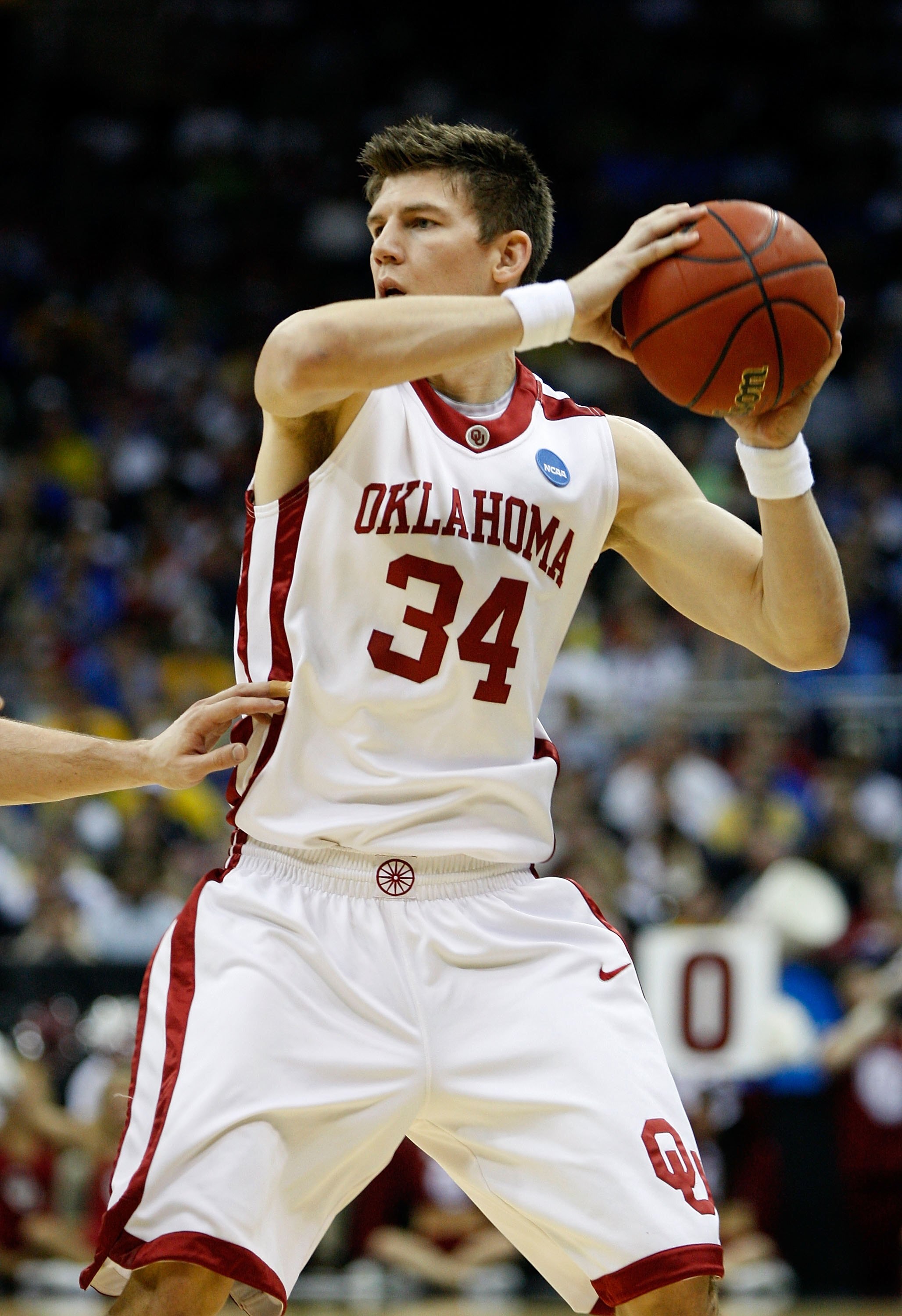 KANSAS CITY, MO - MARCH 21:  Cade Davis #34 of the Oklahoma Sooners looks to make a play with the ball during their second round game against the Michigan Wolverines in the NCAA Division I Men's Basketball Tournament at the Sprint Center on March 21, 2009