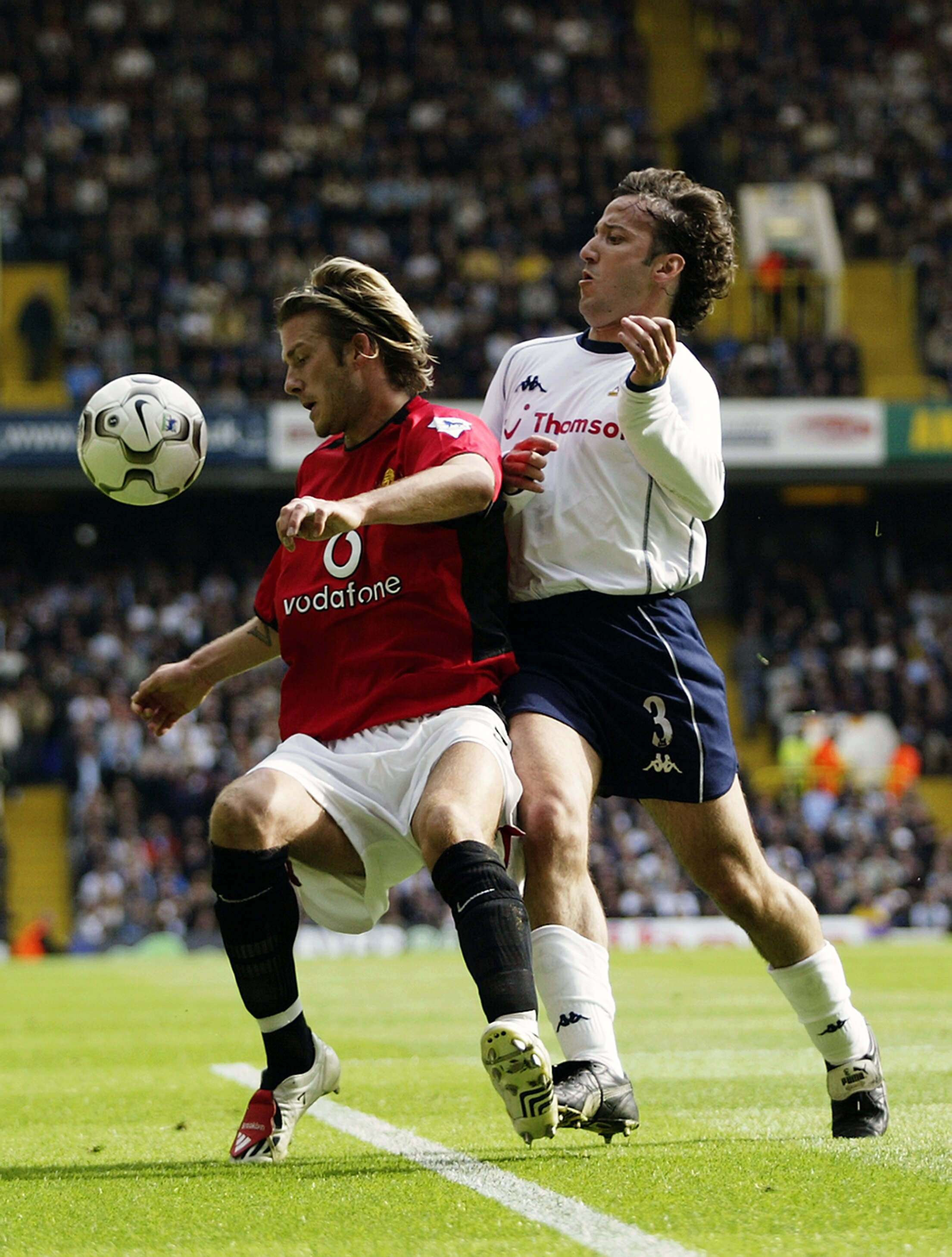 LONDON - APRIL 27:   David Beckham of Manchester United shields the ball from Mauricio Taricco of Tottenham Hotspur during the FA Barclaycard Premiership match between Tottenham Hotspur and Manchester United on April 27, 2003 at White Hart Lane in London.