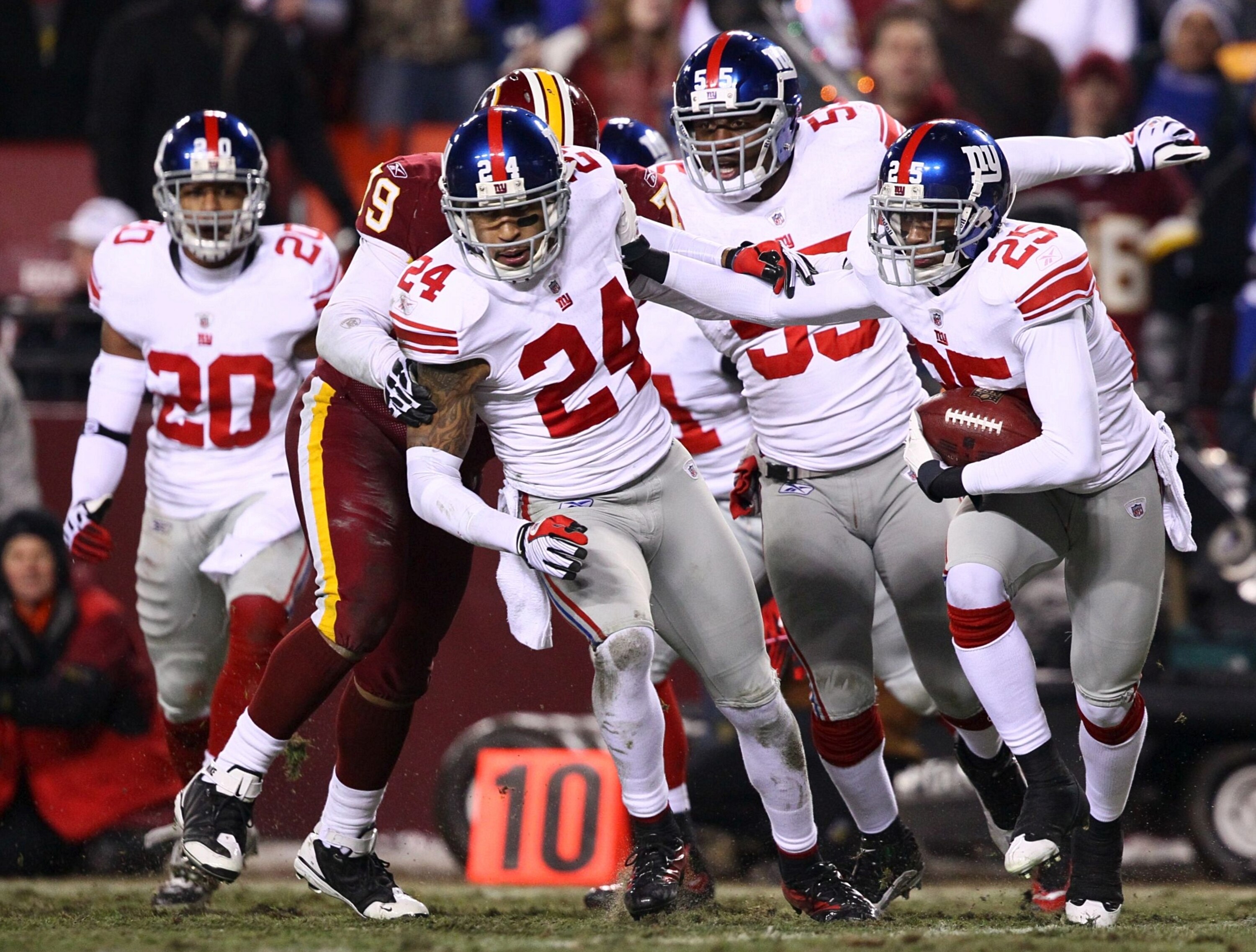 LANDOVER, MD - DECEMBER 21:  Cornerback Bruce Johnson #25 of the New York Giants runs with the ball after intercepting punter Hunter Smith #3 of the Washington Redskins at FedEx Field on December 21, 2009 in Landover, Maryland. (Photo by Win McNamee/Getty