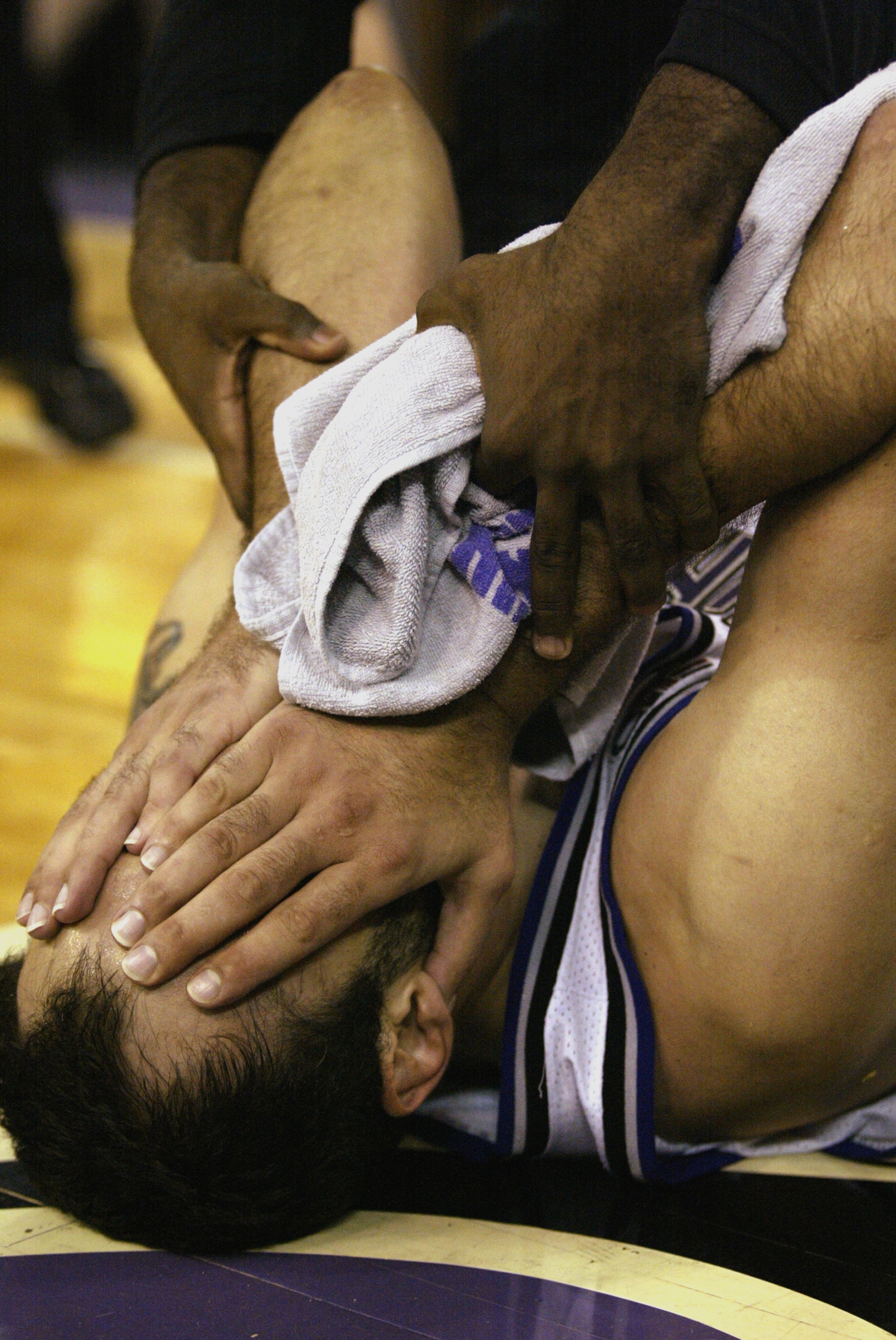 SACRAMENTO, CA - JUNE 2:  Center Vlade Divac #21 of the Sacramento Kings covers his face in Game Seven of the Western Conference Finals against the Los Angeles Lakers during the 2002 NBA Playoffs at Arco Arena in Sacramento, California on June 2, 2002.  T