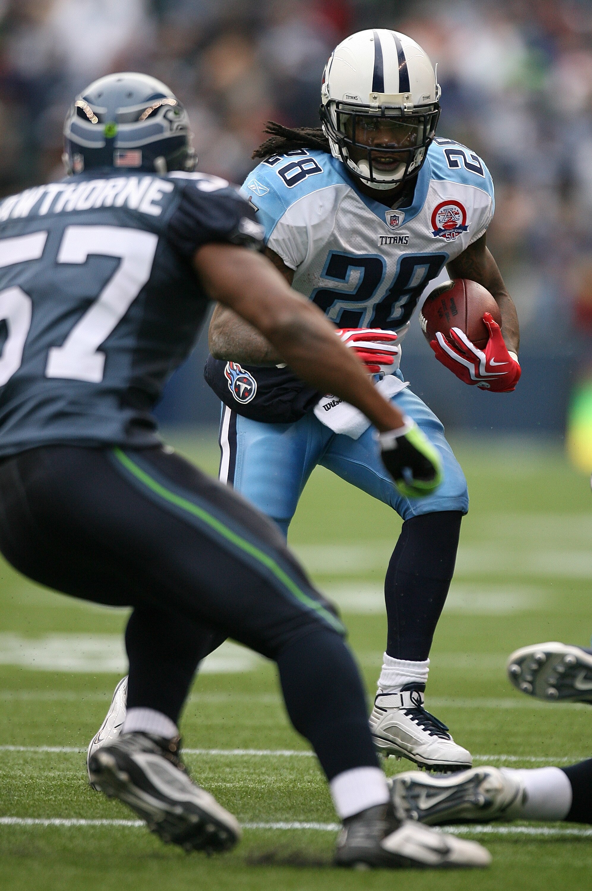 SEATTLE - JANUARY 03:  Running back Chris Johnson #28 of the Tennessee Titans rushes against David Hawthorne #57 of the Seattle Seahawks on January 3, 2010 at Qwest Field in Seattle, Washington. (Photo by Otto Greule Jr/Getty Images)