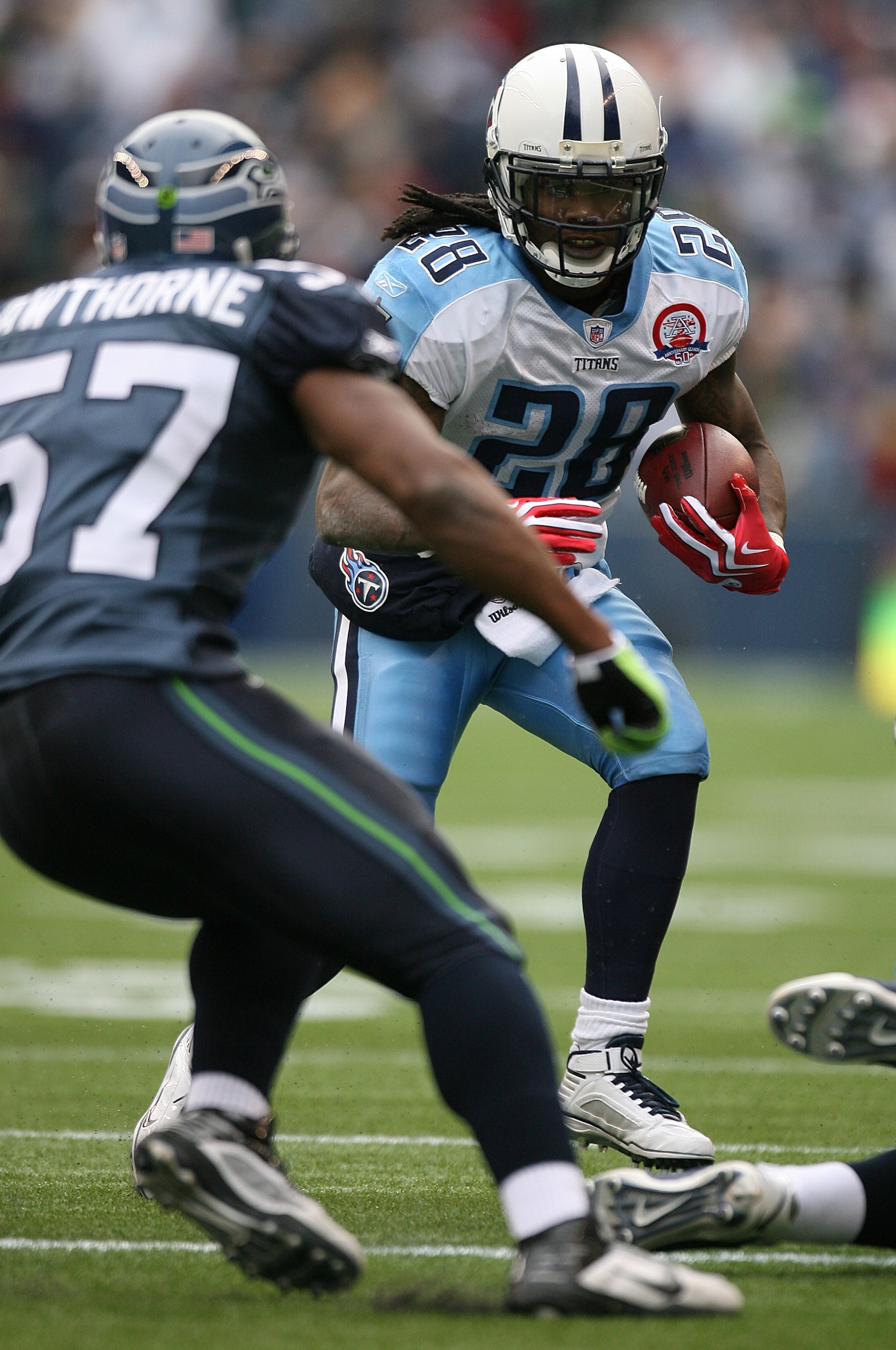 SEATTLE - JANUARY 03: Running back Chris Johnson #28 of the Tennessee Titans rushes against David Hawthorne #57 of the Seattle Seahawks on January 3, 2010 at Qwest Field in Seattle, Washington. (Photo by Otto Greule Jr/Getty Images) SEATTLE - JANUARY 03: Running back Chris Johnson #28 of the Tennessee Titans rushes against David Hawthorne #57 of the Seattle Seahawks on January 3, 2010 at Qwest Field in Seattle, Washington. (Photo by Otto Greule Jr/Getty Images)