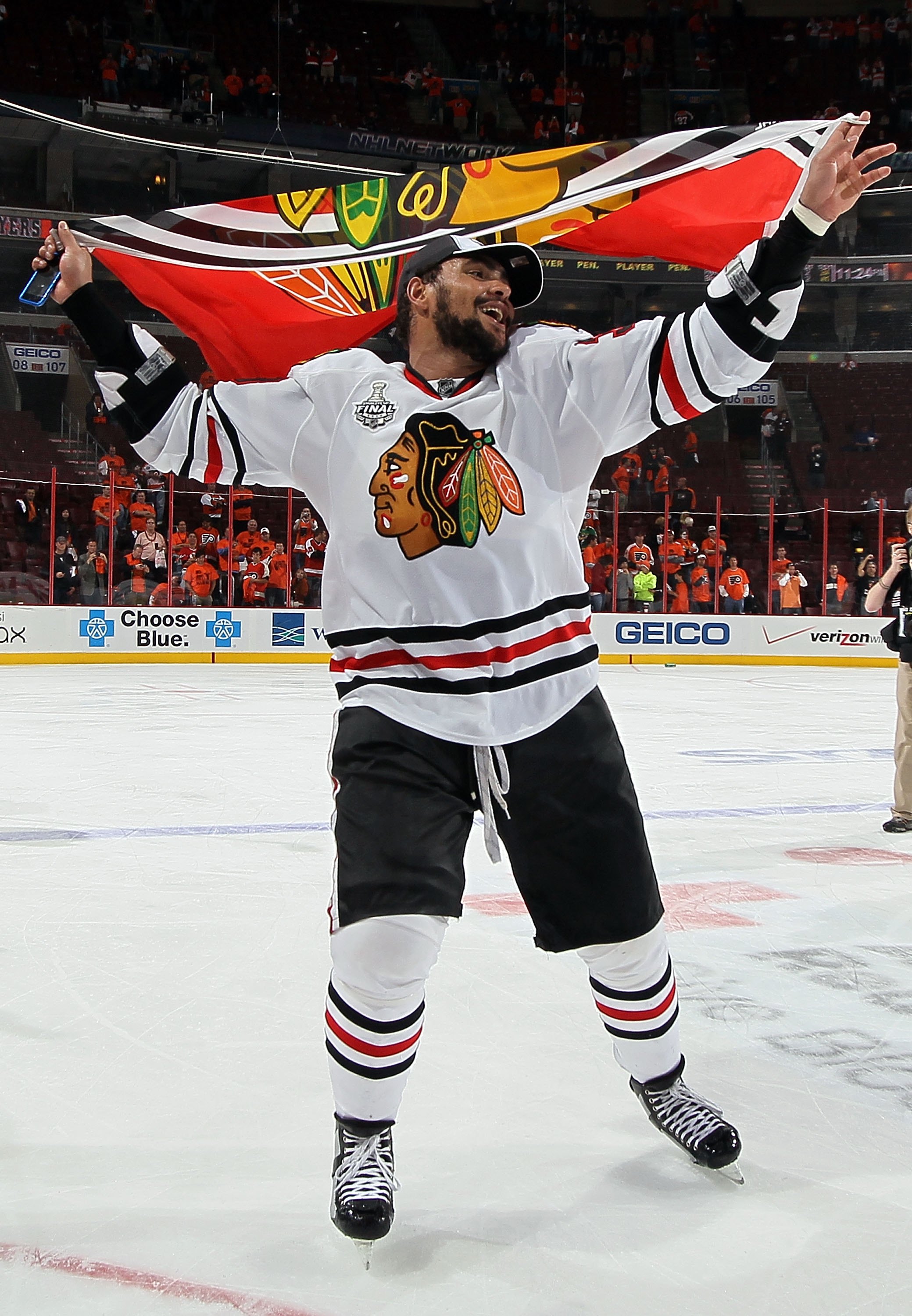 PHILADELPHIA - JUNE 09: Dustin Byfuglien #33 of the Chicago Blackhawks skates with the Blackhawks flag after teammate Patrick Kane #88 scored the game-winning goal in overtime to defeat the Philadelphia Flyers 4-3 and win the Stanley Cup in Game Six of th