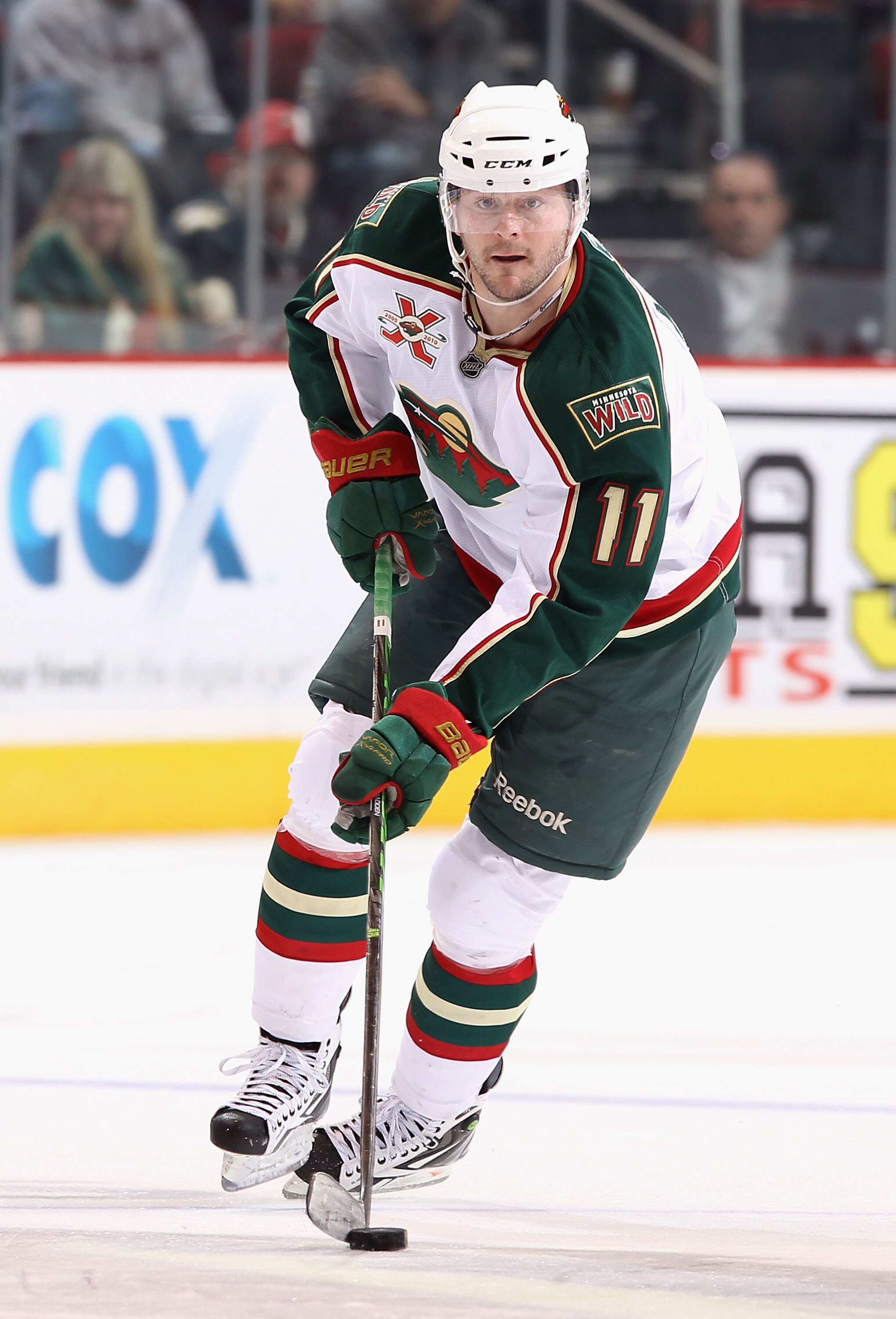 GLENDALE, AZ - DECEMBER 09:  John Madden #11 of the Minnesota Wild skates with the puck during the NHL game against the Phoenix Coyotes at Jobing.com Arena on December 9, 2010 in Glendale, Arizona.  The Wild defeated the Coyotes 3-2.  (Photo by Christian