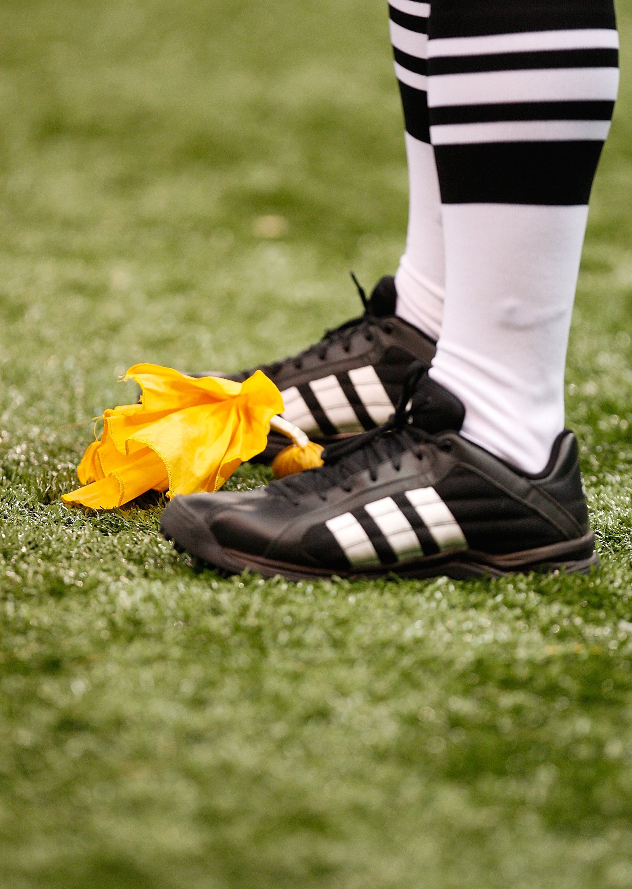 NEW ORLEANS - NOVEMBER 07:  A referee stands over a yellow penalty flag during a game between the UTEP Miners and the Tulane Green Wave at Louisana Superdome on November 7, 2009 in New Orleans, Louisiana.  (Photo by Ronald Martinez/Getty Images)