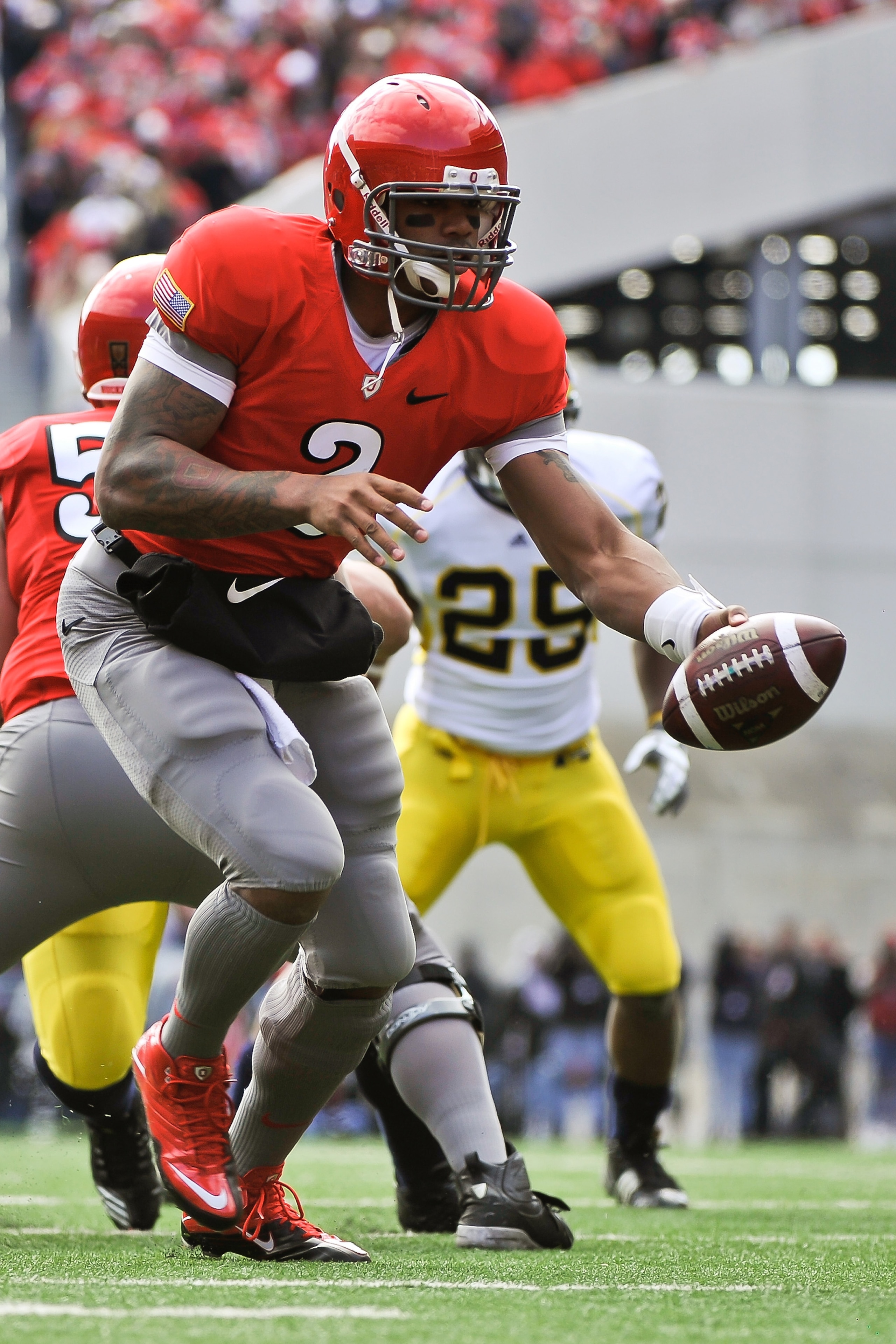 COLUMBUS, OH - NOVEMBER 27:  Quarterback Terrelle Pryor #2 of the Ohio State Buckeyes hands off against the Michigan Wolverines at Ohio Stadium on November 27, 2010 in Columbus, Ohio.  (Photo by Jamie Sabau/Getty Images)