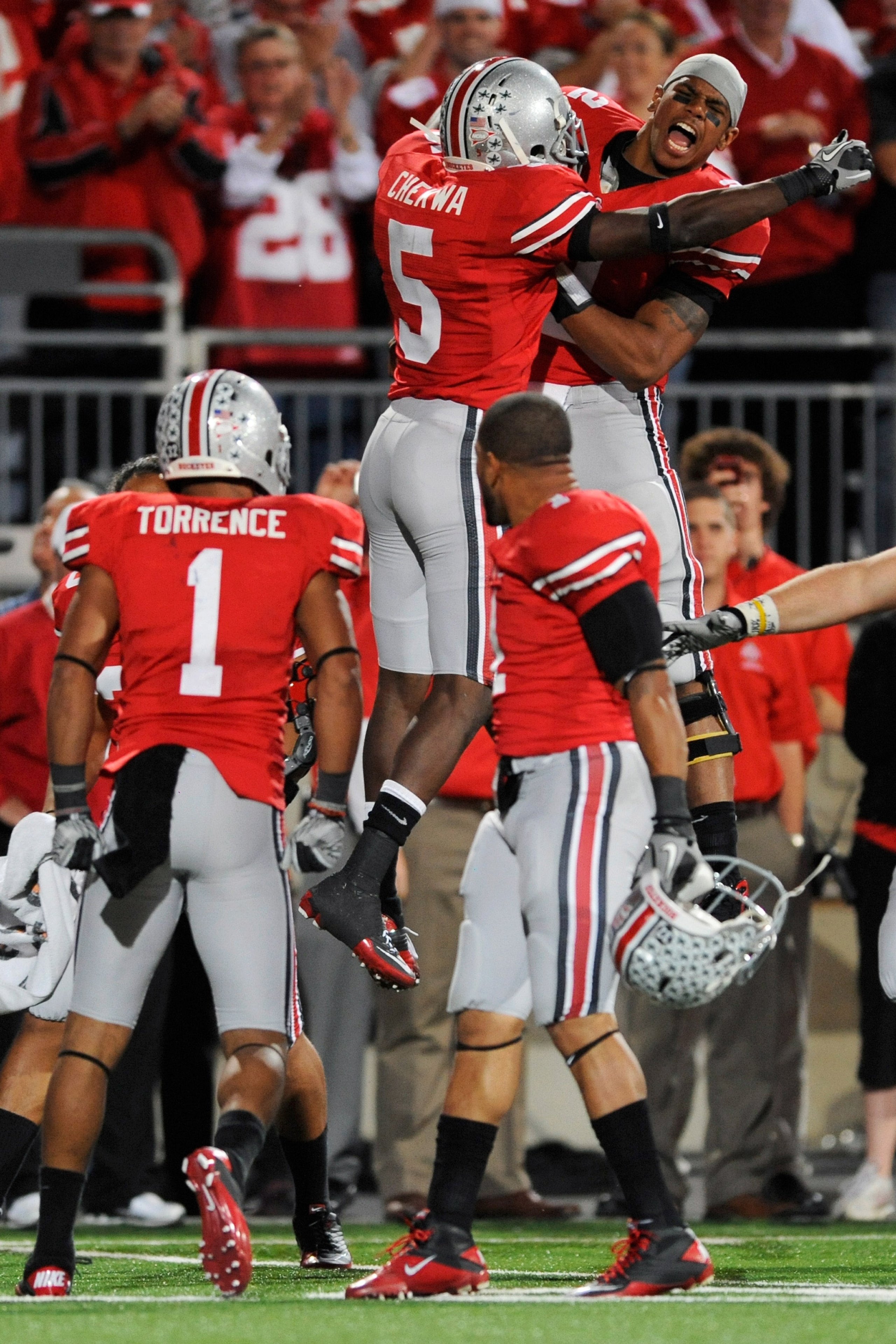 COLUMBUS, OH - NOVEMBER 13:  Quarterback Terrelle Pryor #2 of the Ohio State Buckeyes celebrates with Chimdi Chekwa #5 of the Ohio State Buckeyes after Devon Torrence returned an interception 34-yards for a touchdown against the Penn State Nittany Lions a