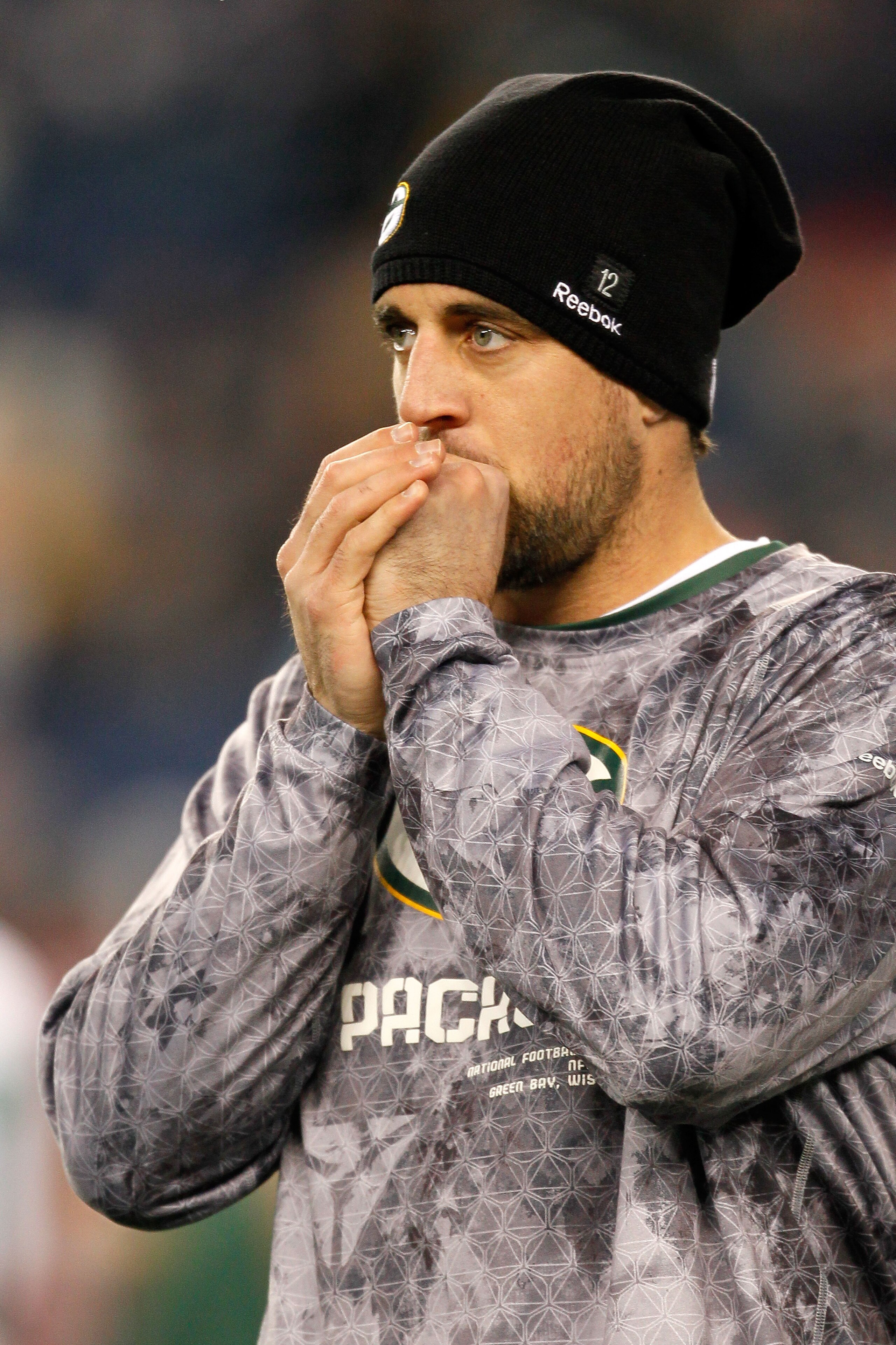 FOXBORO, MA - DECEMBER 19: Quarterback Aaron Rodgers #12 of the Green Bay Packers, inactive due to an injury, looks on during warm-ups before the game against the New England Patriots at Gillette Stadium on December 19, 2010 in Foxboro, Massachusetts. ( FOXBORO, MA - DECEMBER 19: Quarterback Aaron Rodgers #12 of the Green Bay Packers, inactive due to an injury, looks on during warm-ups before the game against the New England Patriots at Gillette Stadium on December 19, 2010 in Foxboro, Massachusetts. (