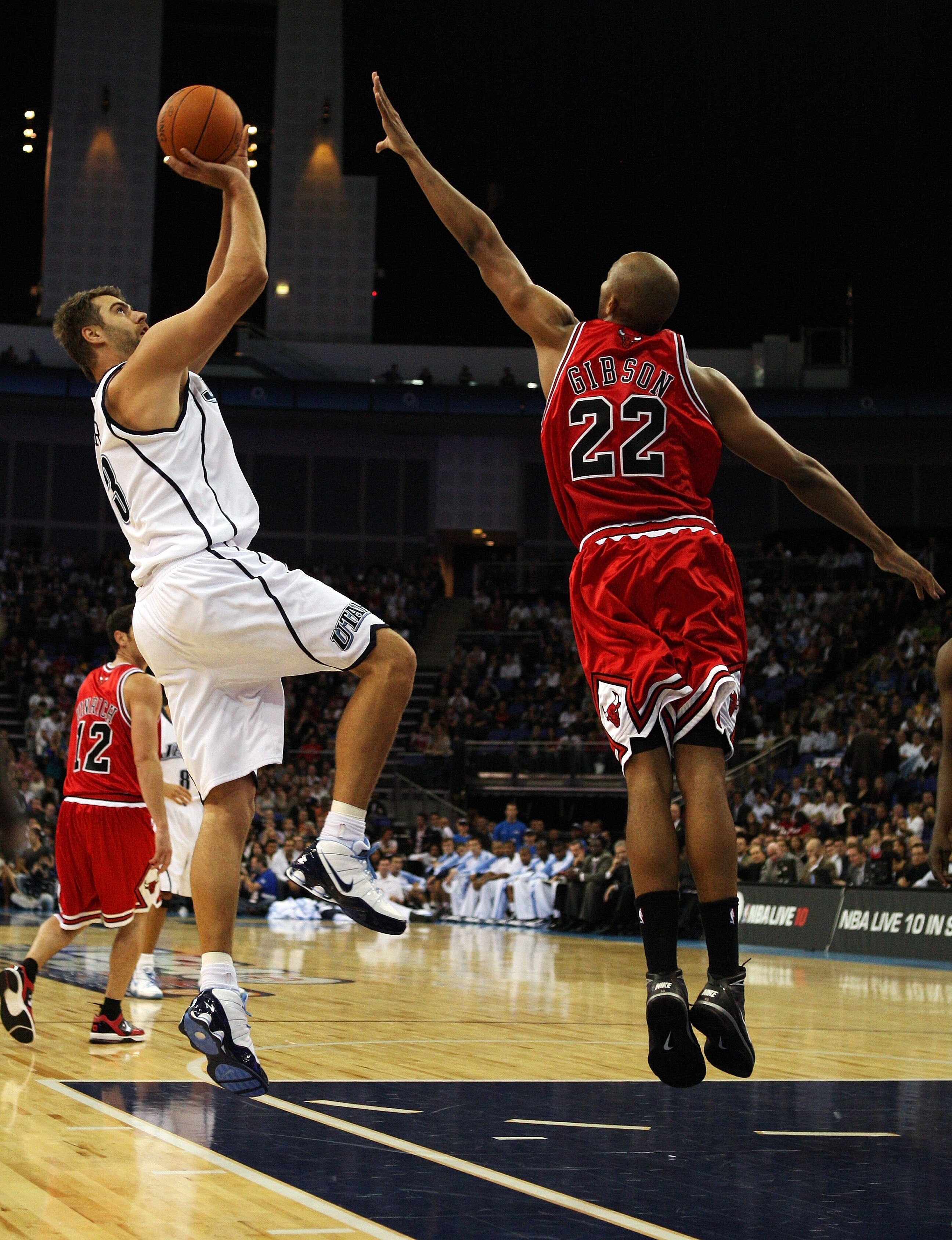 LONDON, ENGLAND - OCTOBER 06:  Taj Gibsonn of the Chicago Bulls attempts the block on Mehmet Okur of the Utah Jazz during the NBA pre-season game as part of the 2009 NBA Europe Live Tour between Chicago Bulls and Utah Jazz at the O2 Arena on October 6, 20