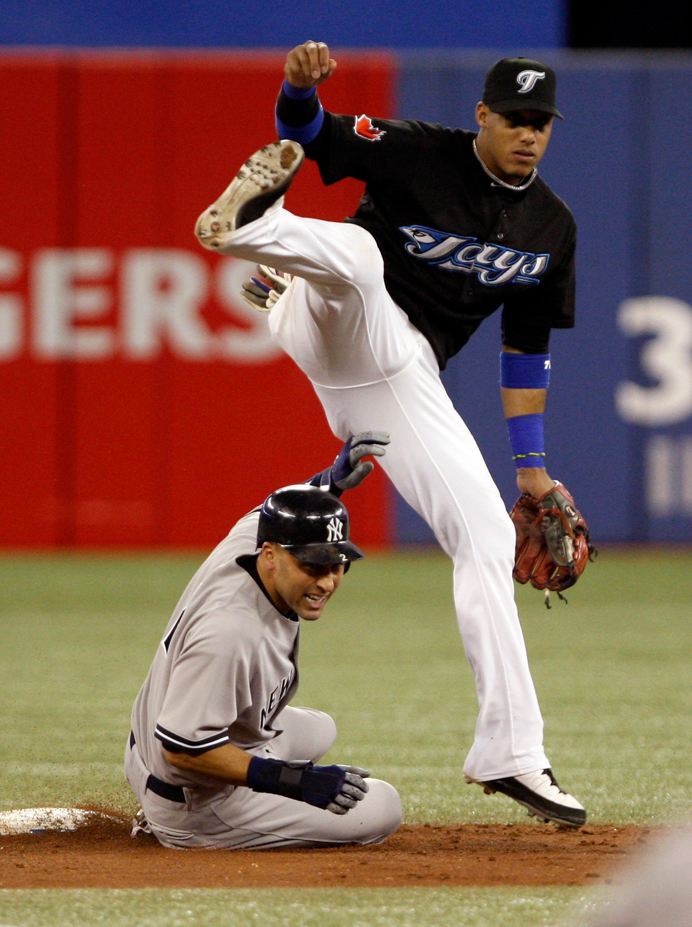 TORONTO, ON - SEPTEMBER 28: Yunel Escobar #5 of the Toronto Blue Jays makes the double play on Derek Jeter #2 of the New York Yankees during an MLB game at the Rogers Centre September 28, 2010 in Toronto, Ontario, Canada. (Photo by Abelimages/Getty Images