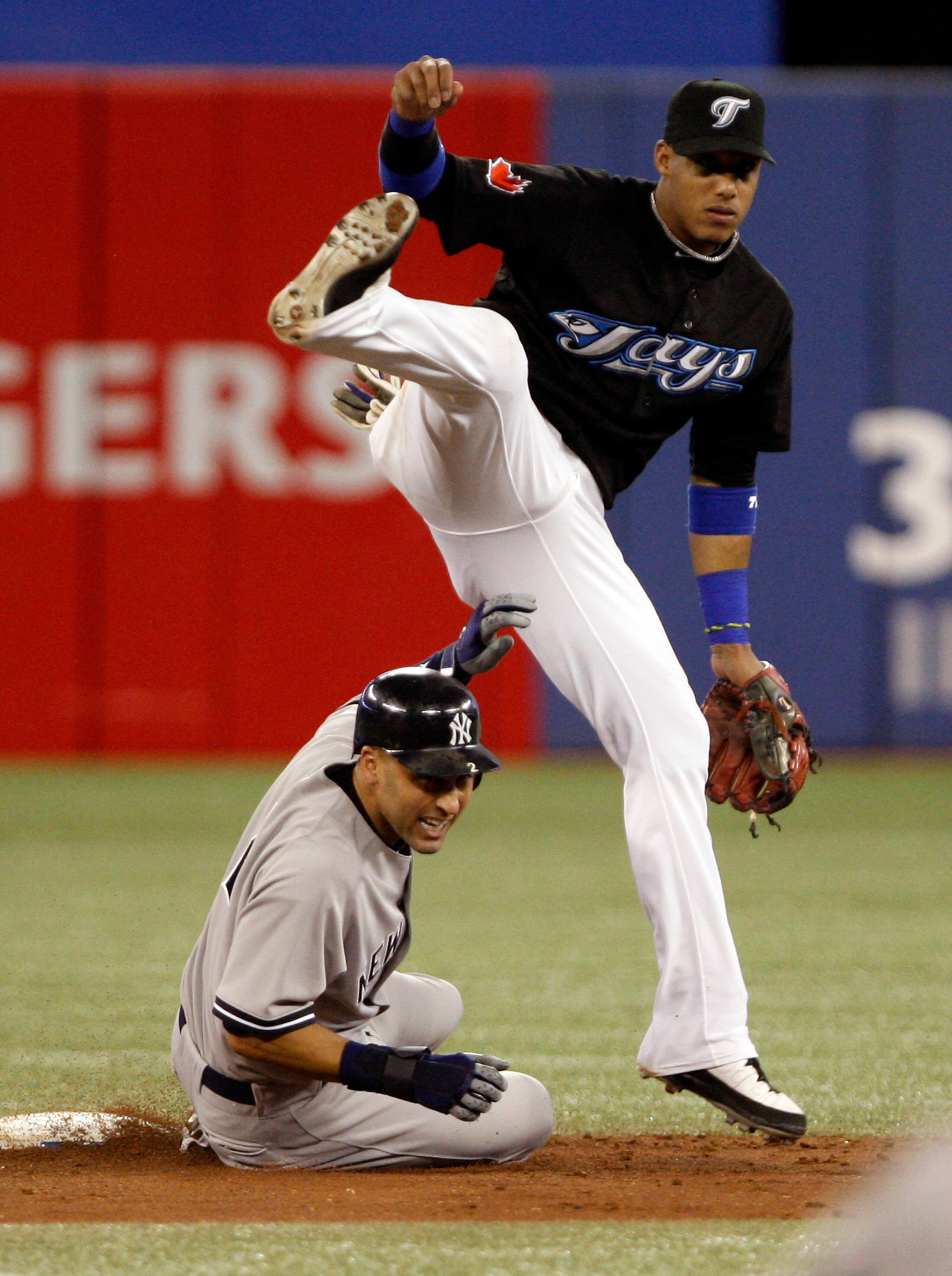 TORONTO, ON - SEPTEMBER 28: Yunel Escobar #5 of the Toronto Blue Jays makes the double play on Derek Jeter #2 of the New York Yankees during an MLB game at the Rogers Centre September 28, 2010 in Toronto, Ontario, Canada. (Photo by Abelimages/Getty Images