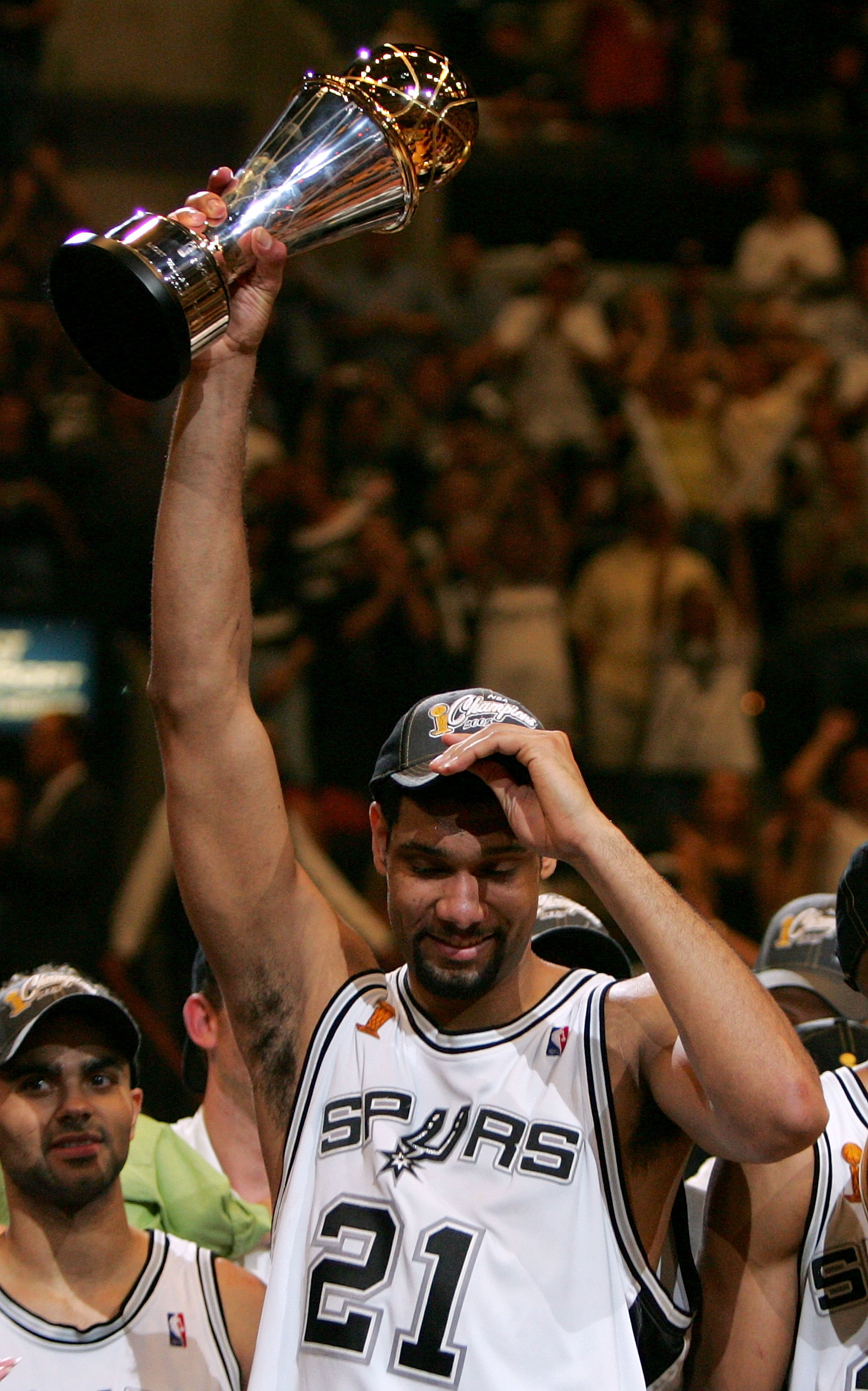 SAN ANTONIO - JUNE 23:  Finals MVP Tim Duncan #21 of the San Antonio Spurs holds up the MVP trophy after the Spurs defeated the Detroit Pistons in Game seven of the 2005 NBA Finals at SBC Center on June 23, 2005 in San Antonio, Texas.  The Spurs defeated 
