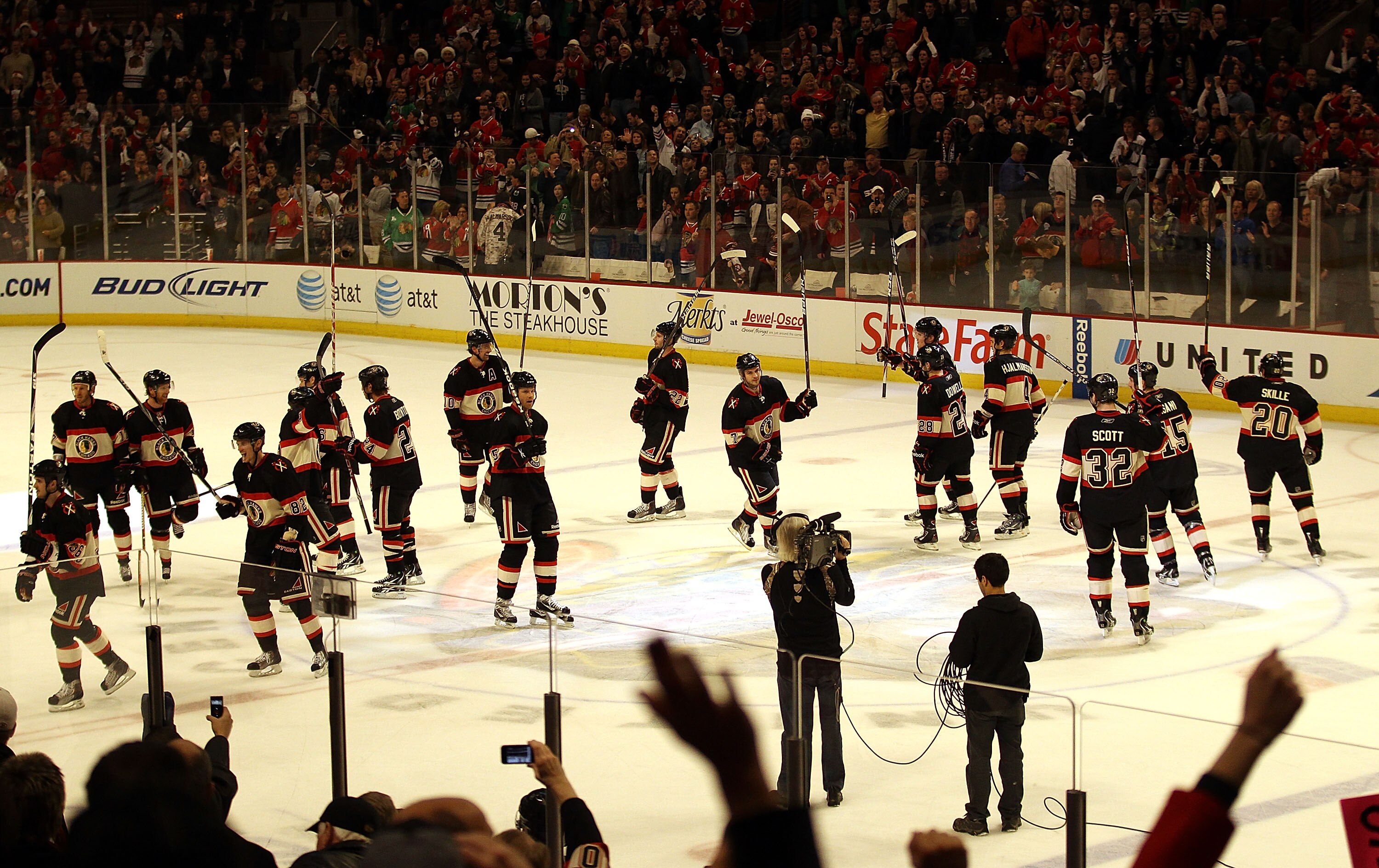 CHICAGO, IL - DECEMBER 22: Members of the Chicago Blackhawks salute the crowd after a win over the Nashville Predators at the United Center on December 22, 2010 in Chicago, Illinois. The Blackhawks defeated the Predators 4-1. (Photo by Jonathan Daniel/Get