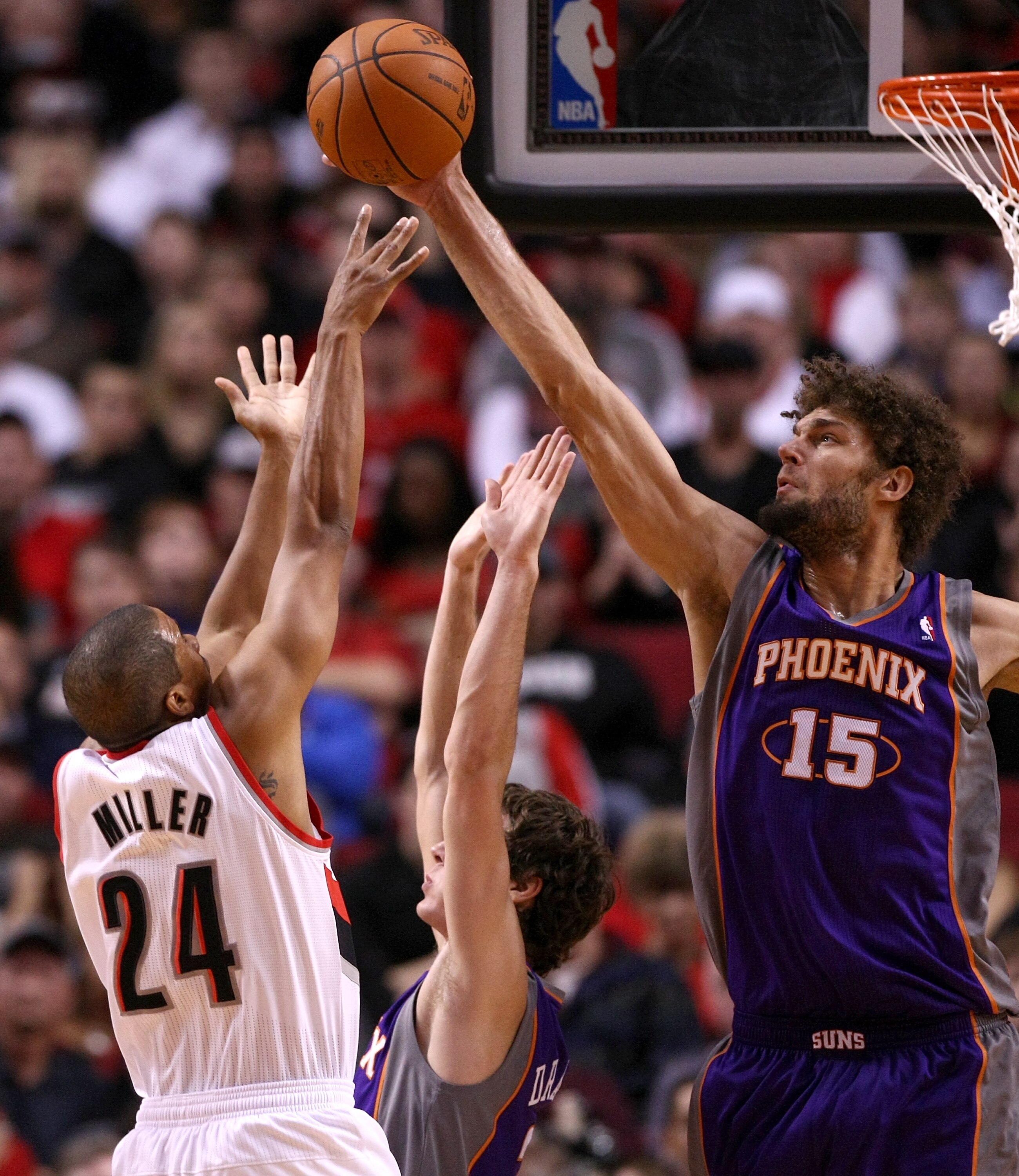 PORTLAND, OR - OCTOBER 26:  Robin Lopez #15 of the Phoeinx Suns blocks a shot by Andre Miller #24 of the Portland Trail Blazers on October 26, 2010 at the Rose Garden in Portland, Oregon.  NOTE TO USER: User expressly acknowledges and agrees that, by down