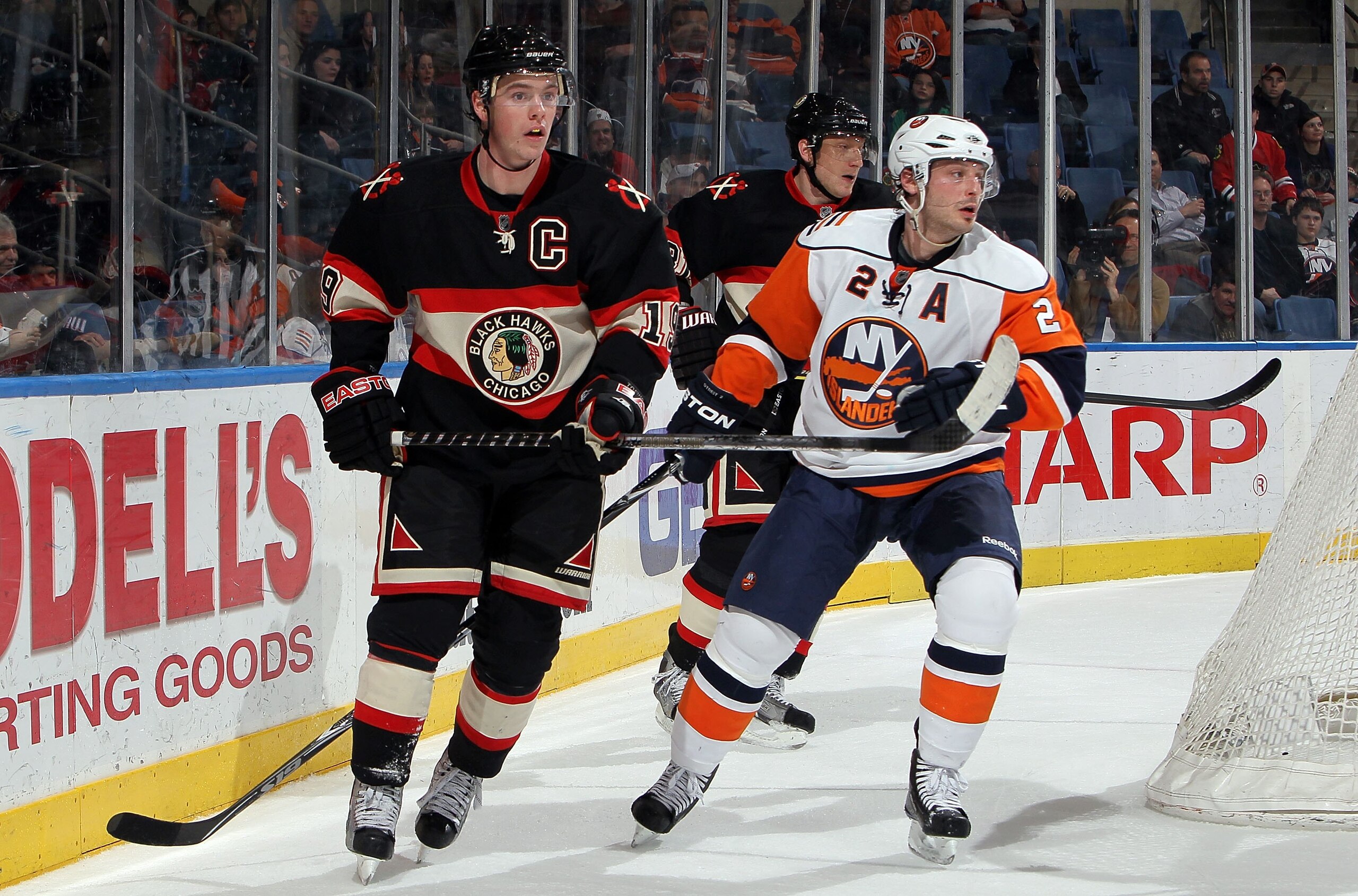 UNIONDALE, NY - MARCH 02:  Jonathan Toews #19 of the Chicago Blackhawks skates against Mark Streit #2 of the New York Islanders on March 2, 2010 at Nassau Coliseum in Uniondale, New York. The Isles defeated the Hawks 5-3.  (Photo by Jim McIsaac/Getty Imag